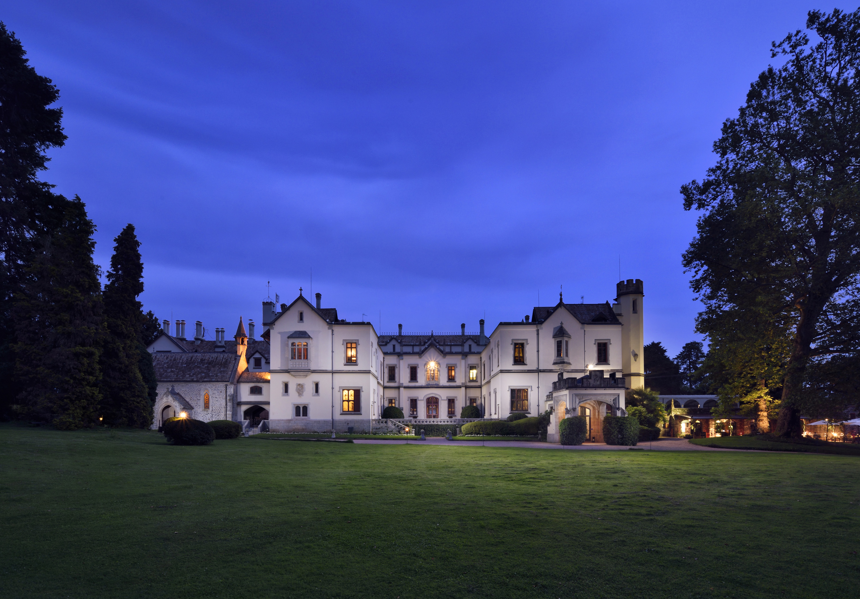 a large white house with a lawn in front of it