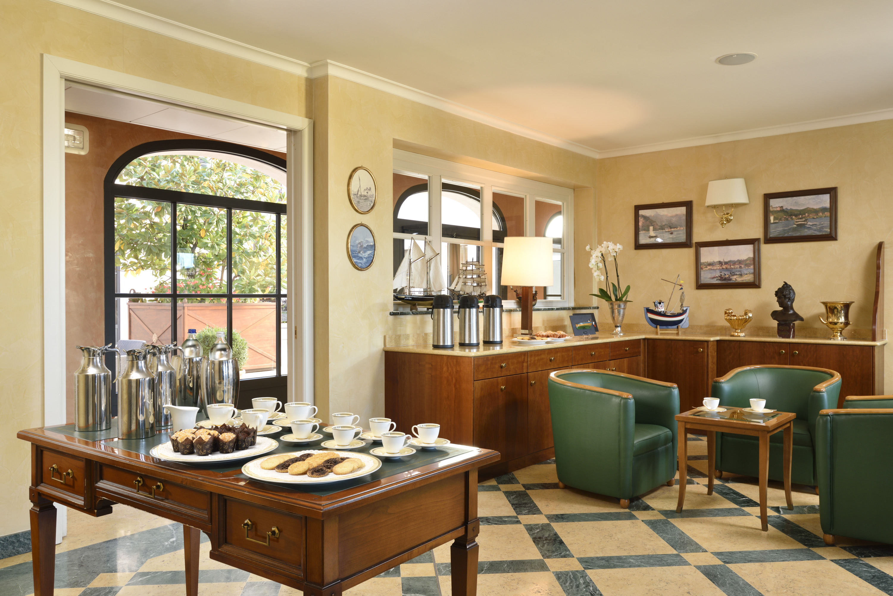 a room with a table and chairs and a table with food on it