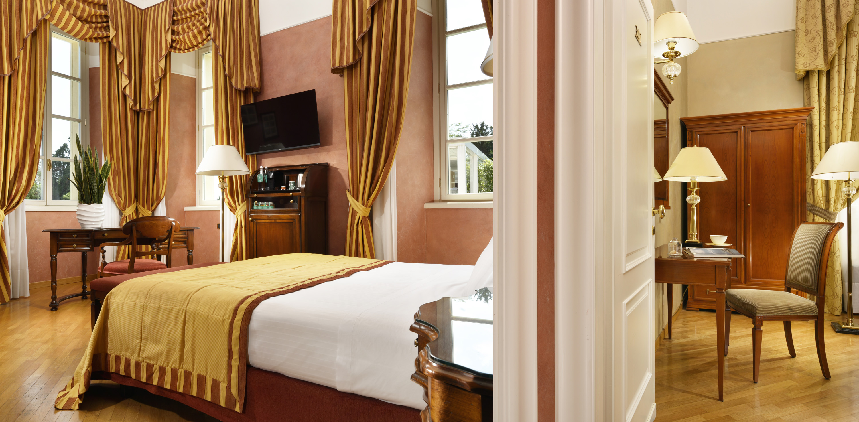 a bedroom with a bed and a television