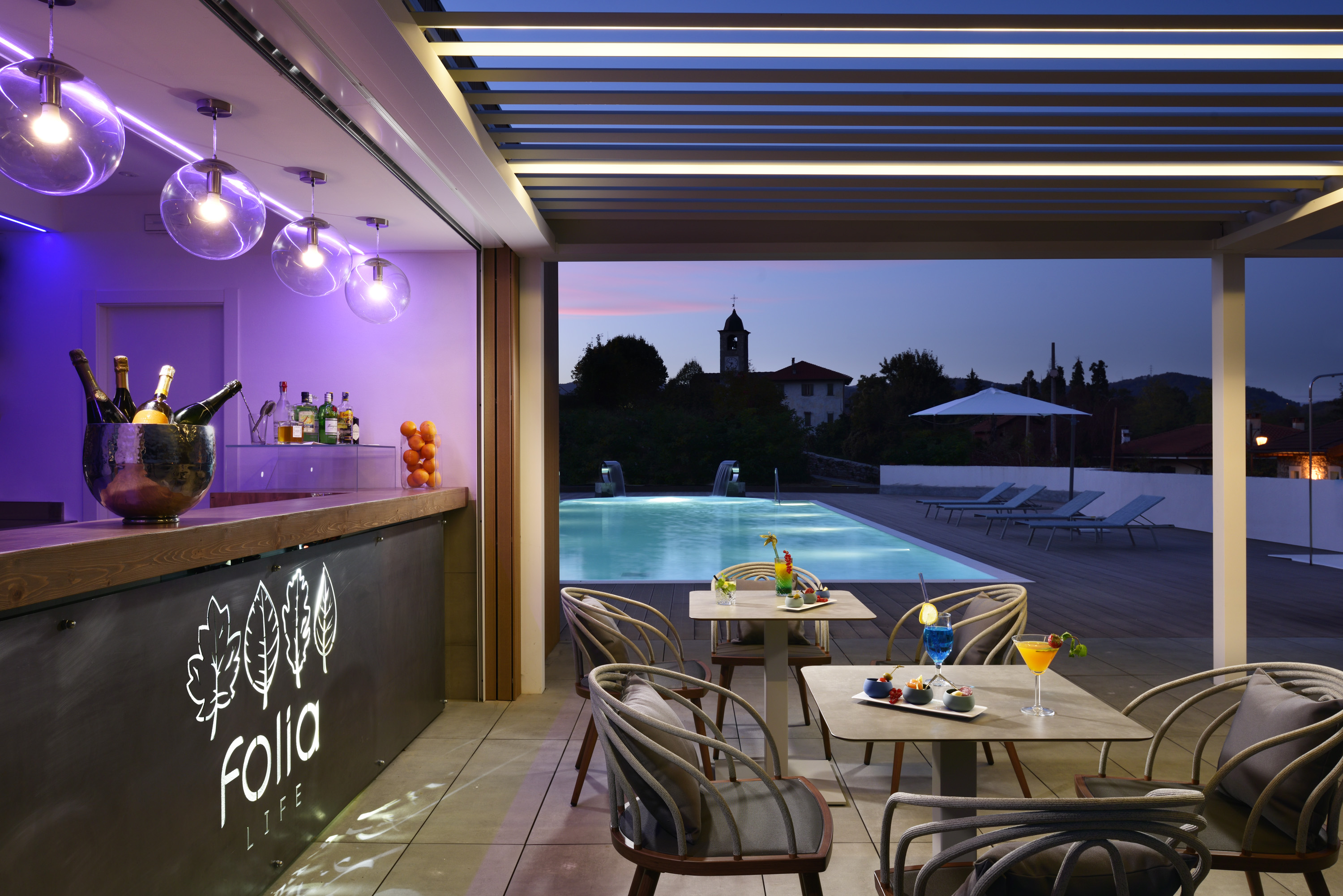 a pool with a bar and tables