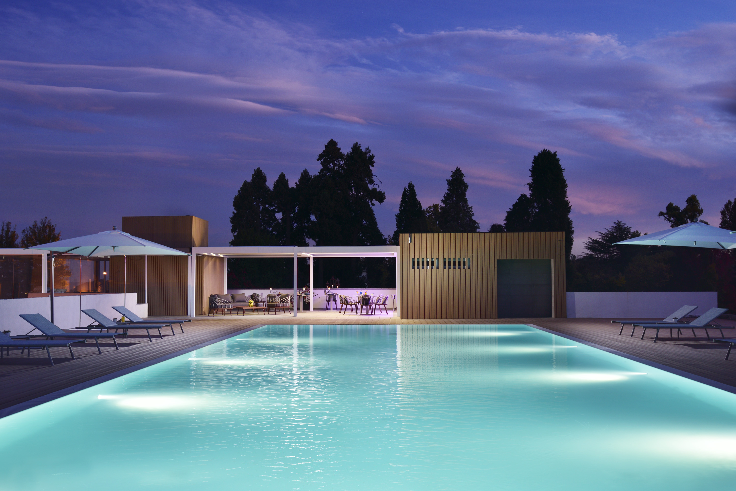 a pool with a deck and chairs