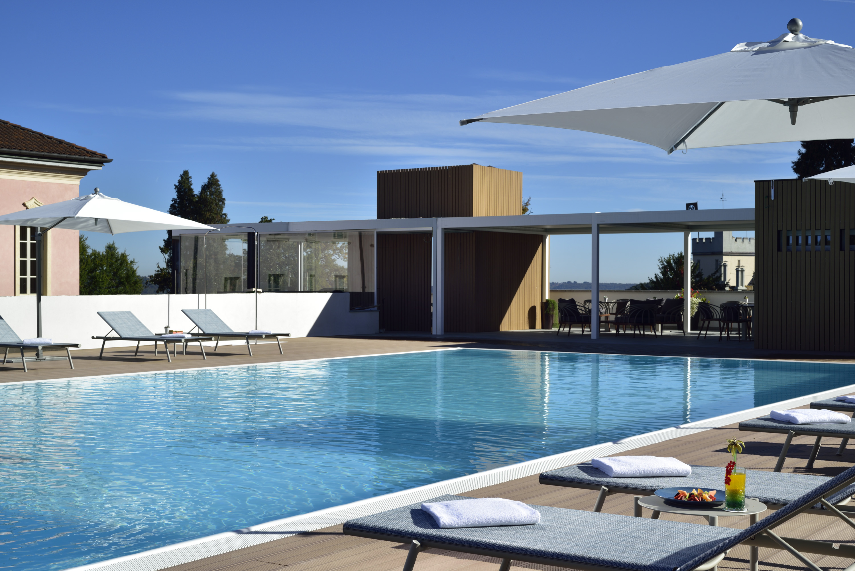 a pool with lounge chairs and umbrellas