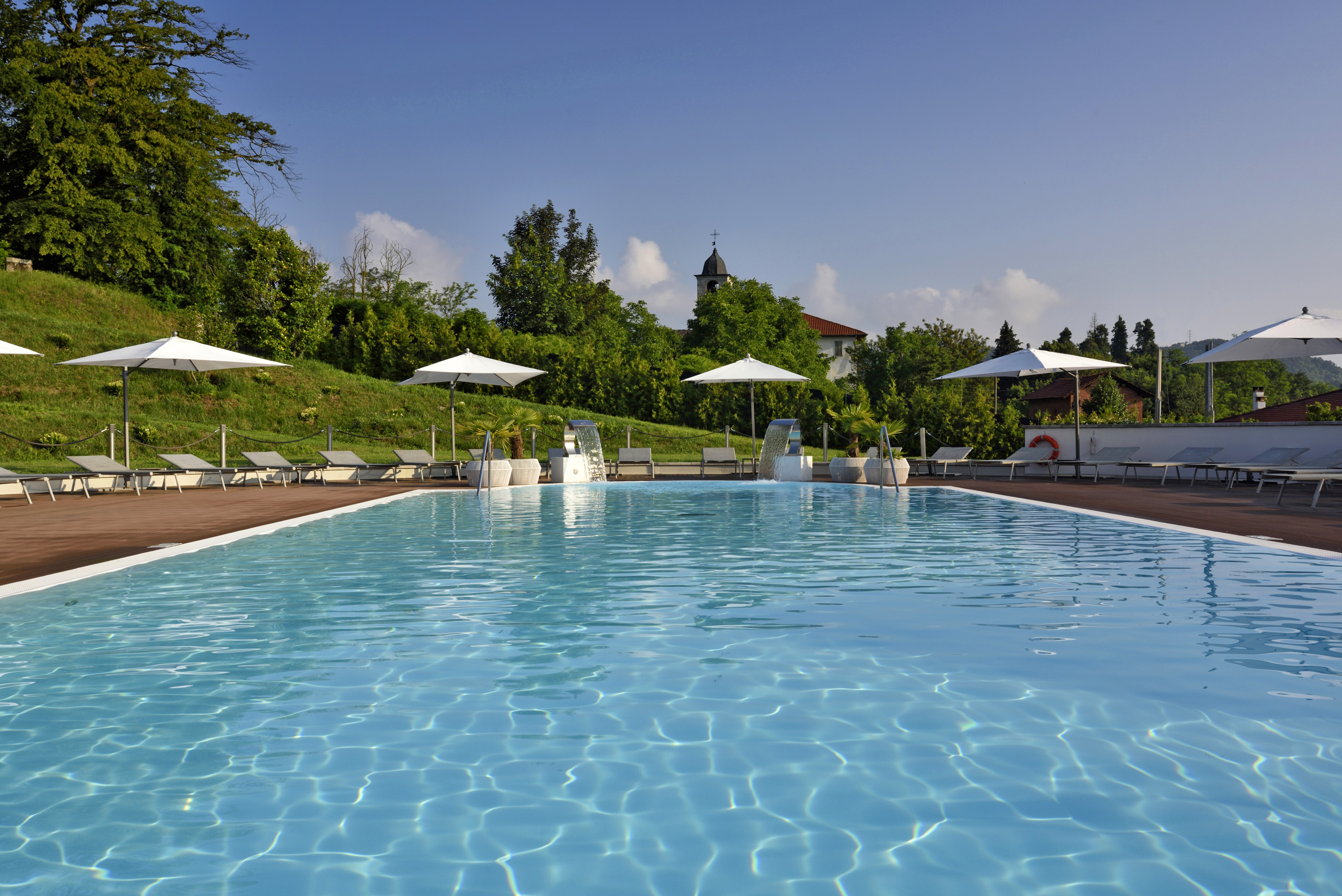 a pool with umbrellas and chairs