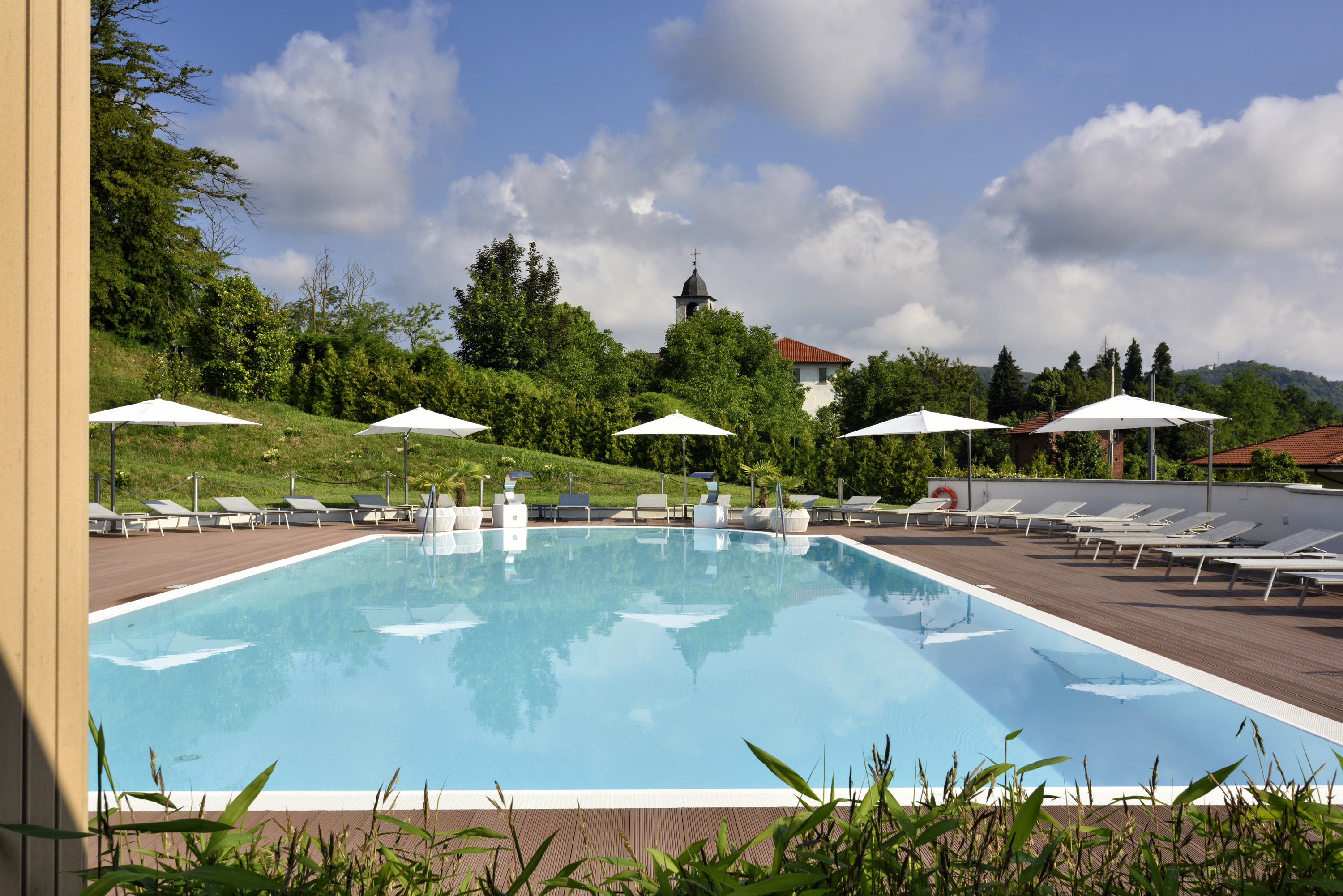 a pool with white umbrellas and chairs