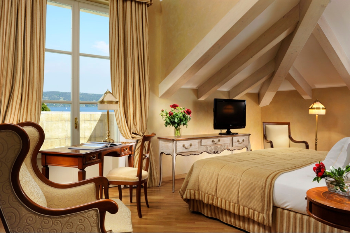 a bedroom with a bed and a desk and chair