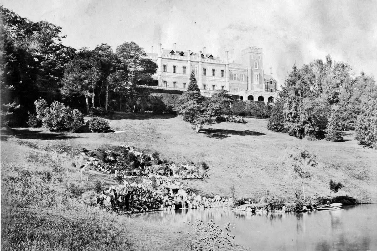a building with trees and a pond