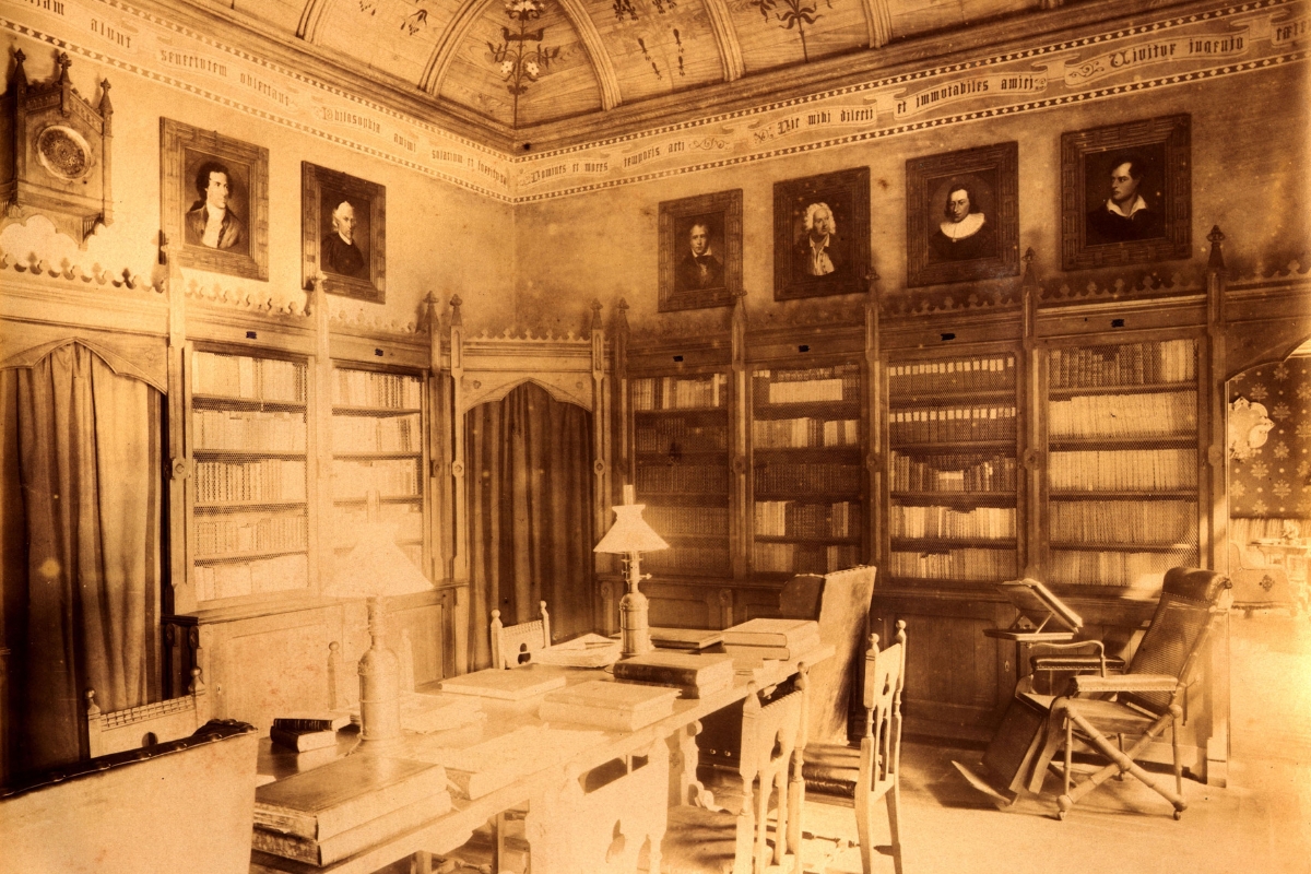 a room with a desk and bookshelves