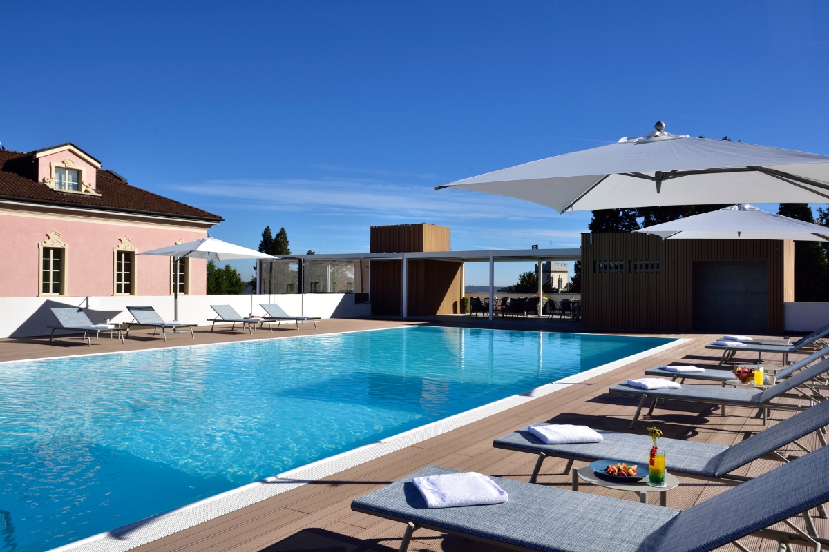 a pool with lounge chairs and umbrellas