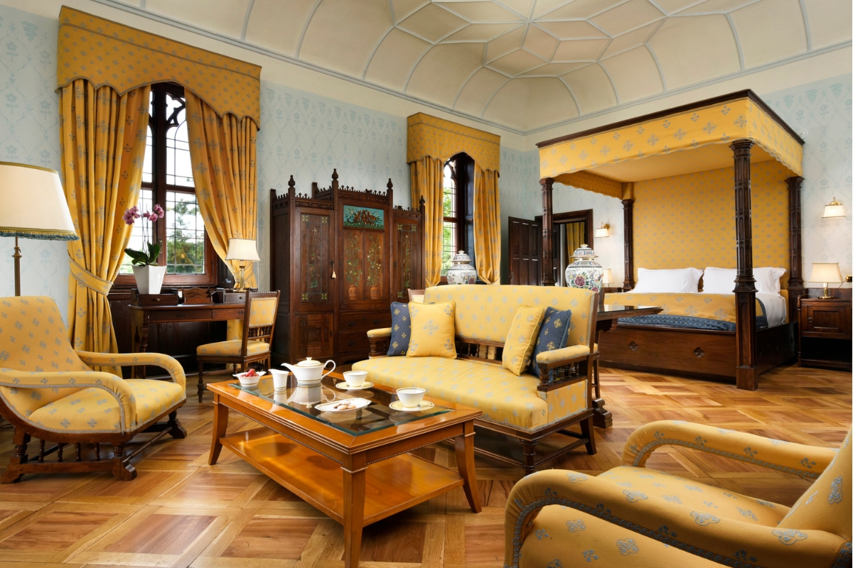 a room with yellow furniture and a table