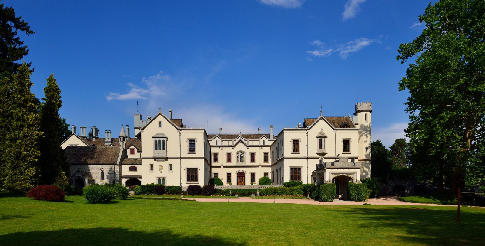 a large white building with a lawn