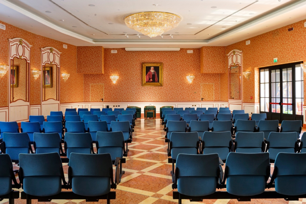 a room with blue chairs and a chandelier
