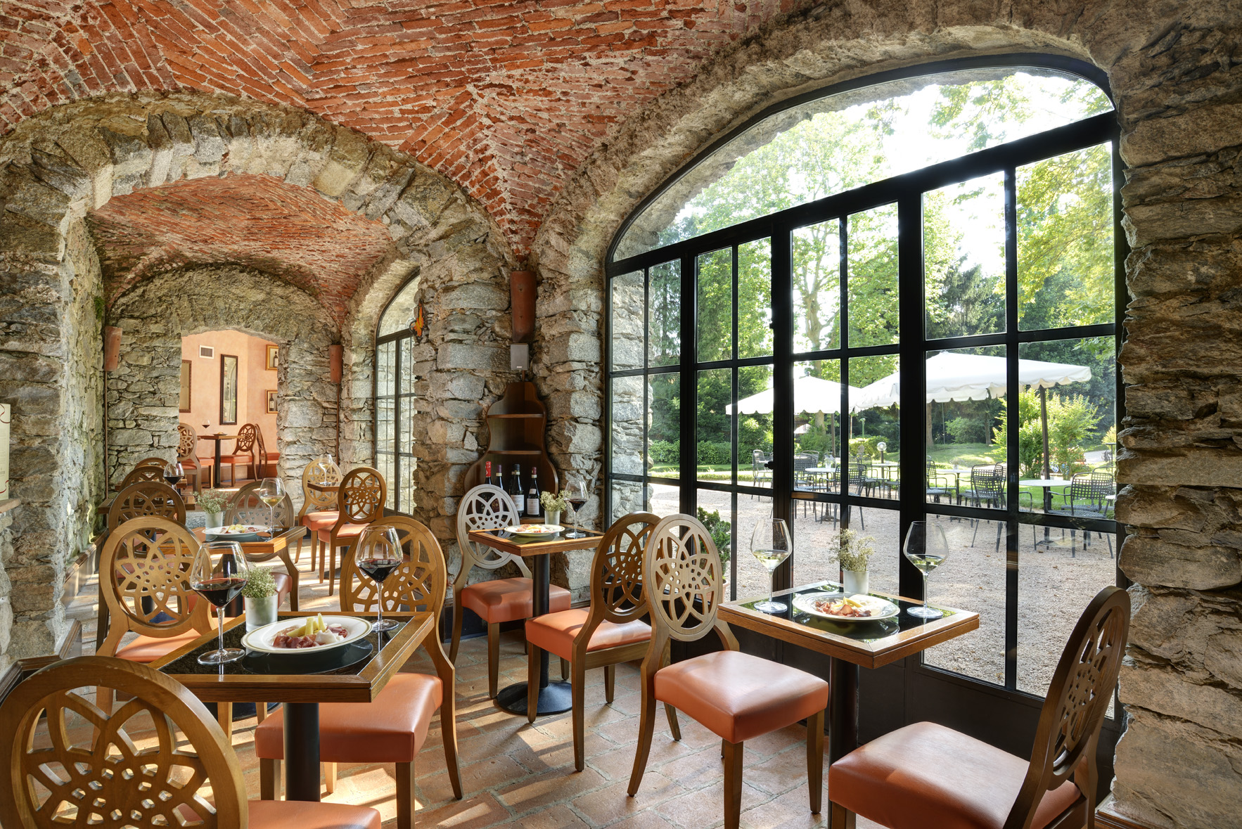 a restaurant with brick walls and tables and chairs