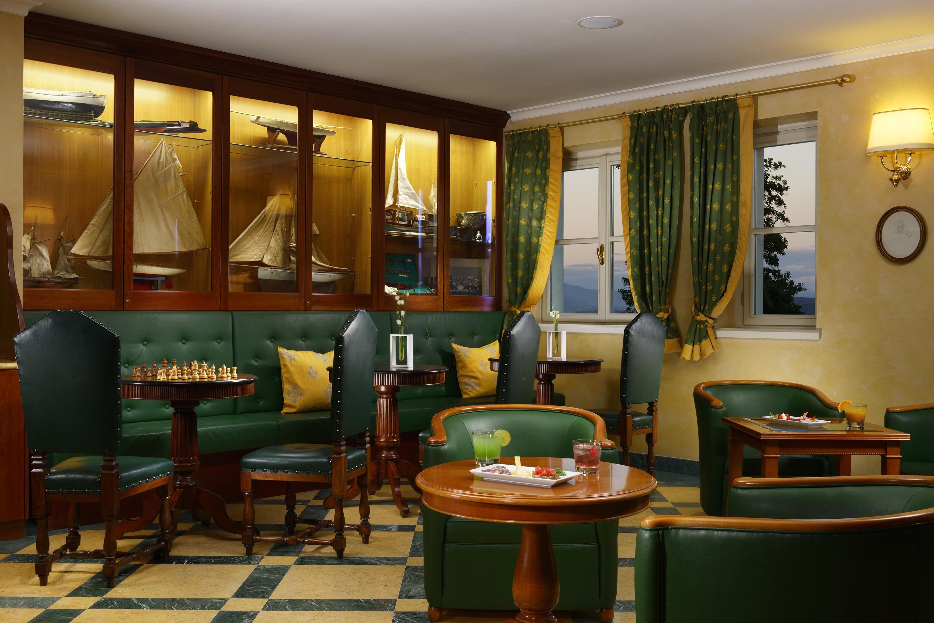 a room with green couches and tables