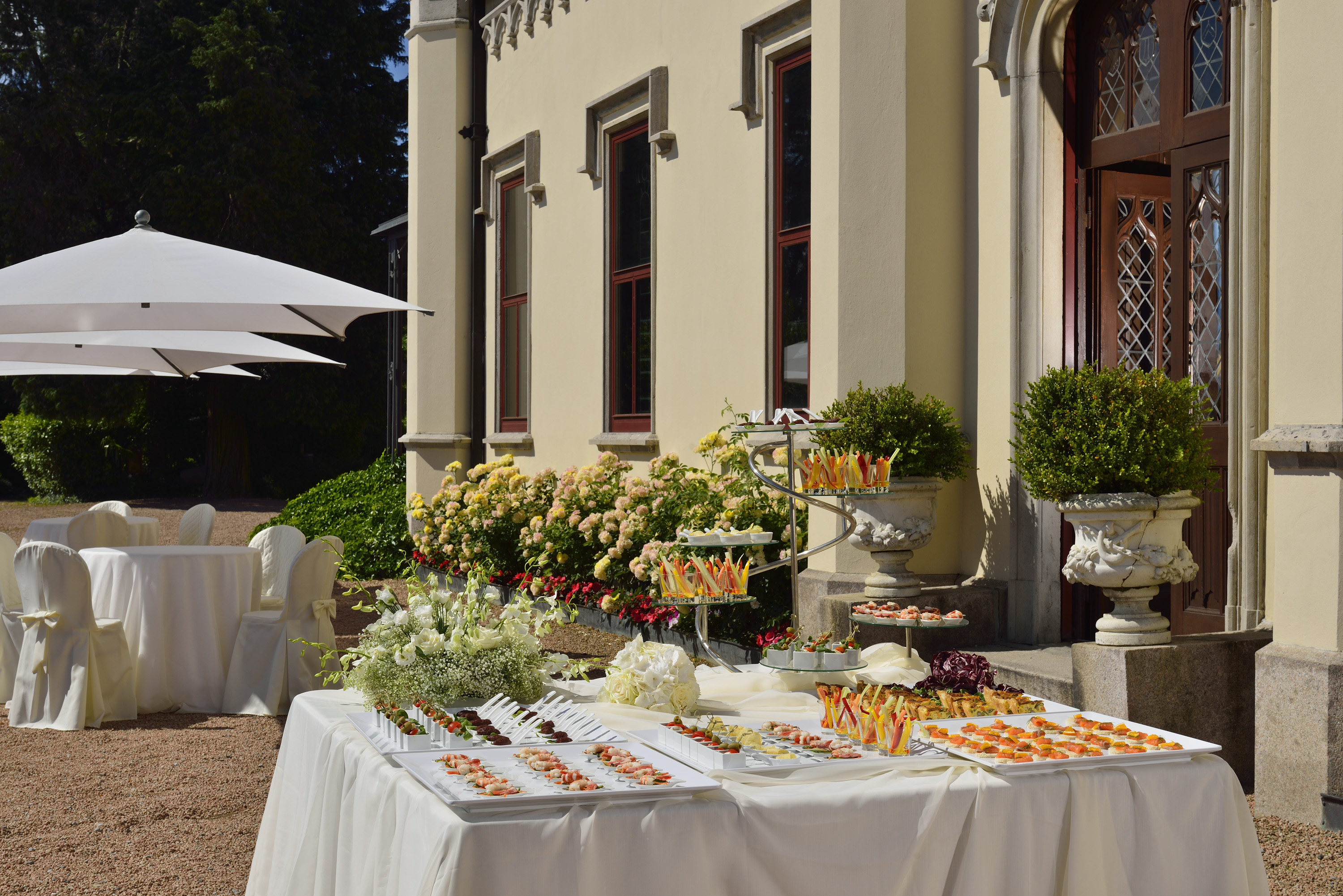 a table with food on it outside of a building