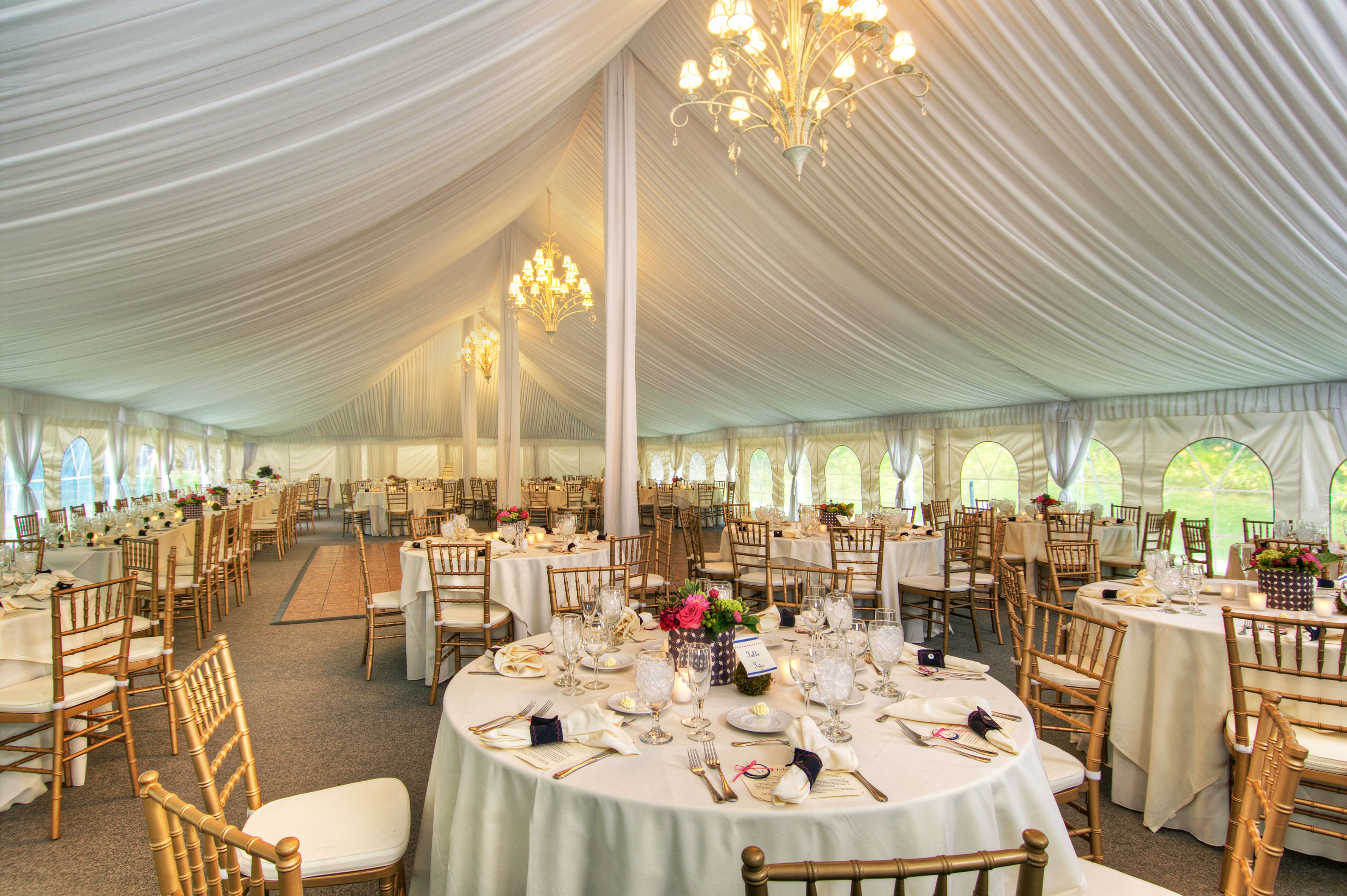 a large tent with tables and chairs