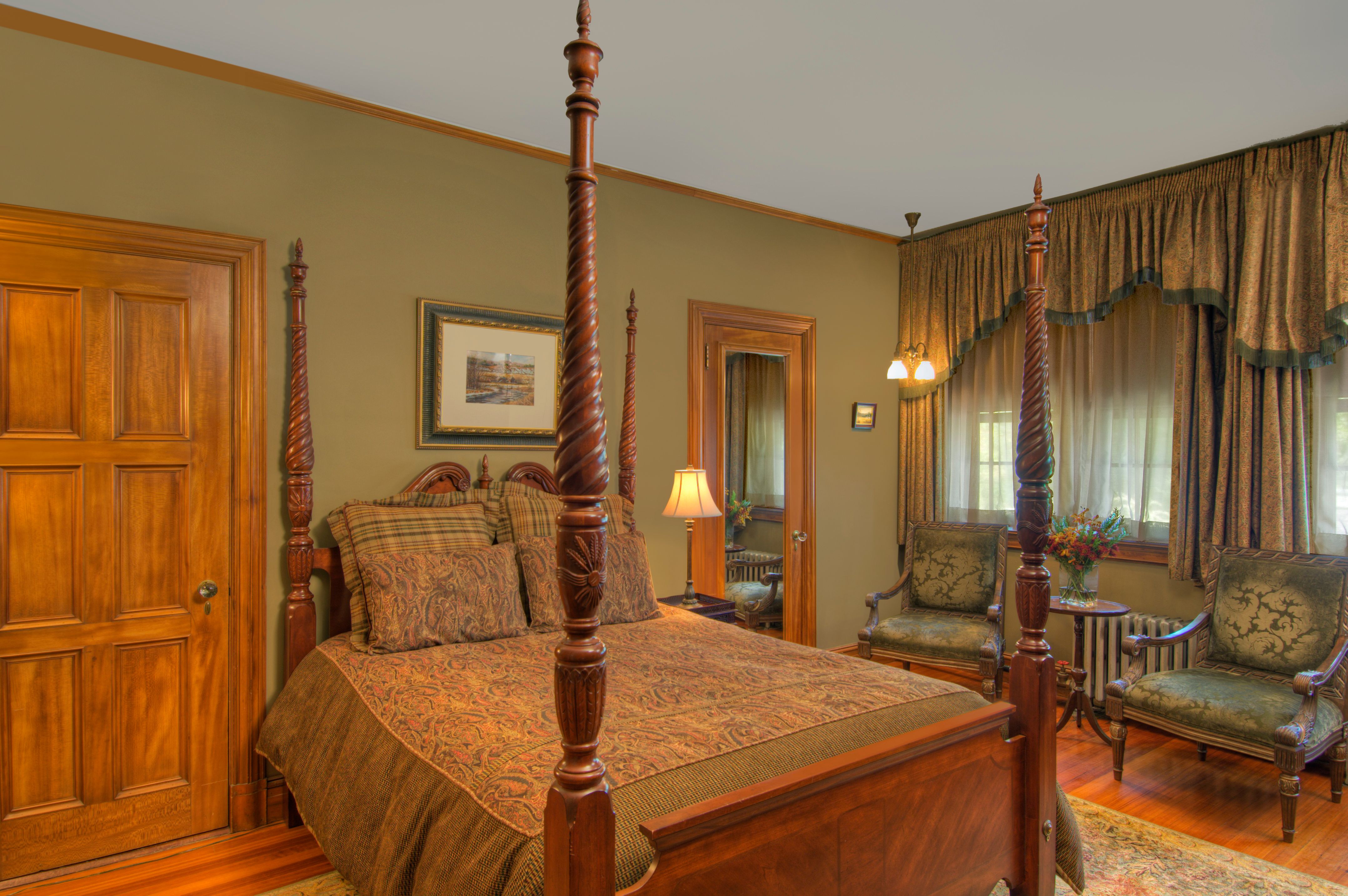 a bedroom with a four poster bed
