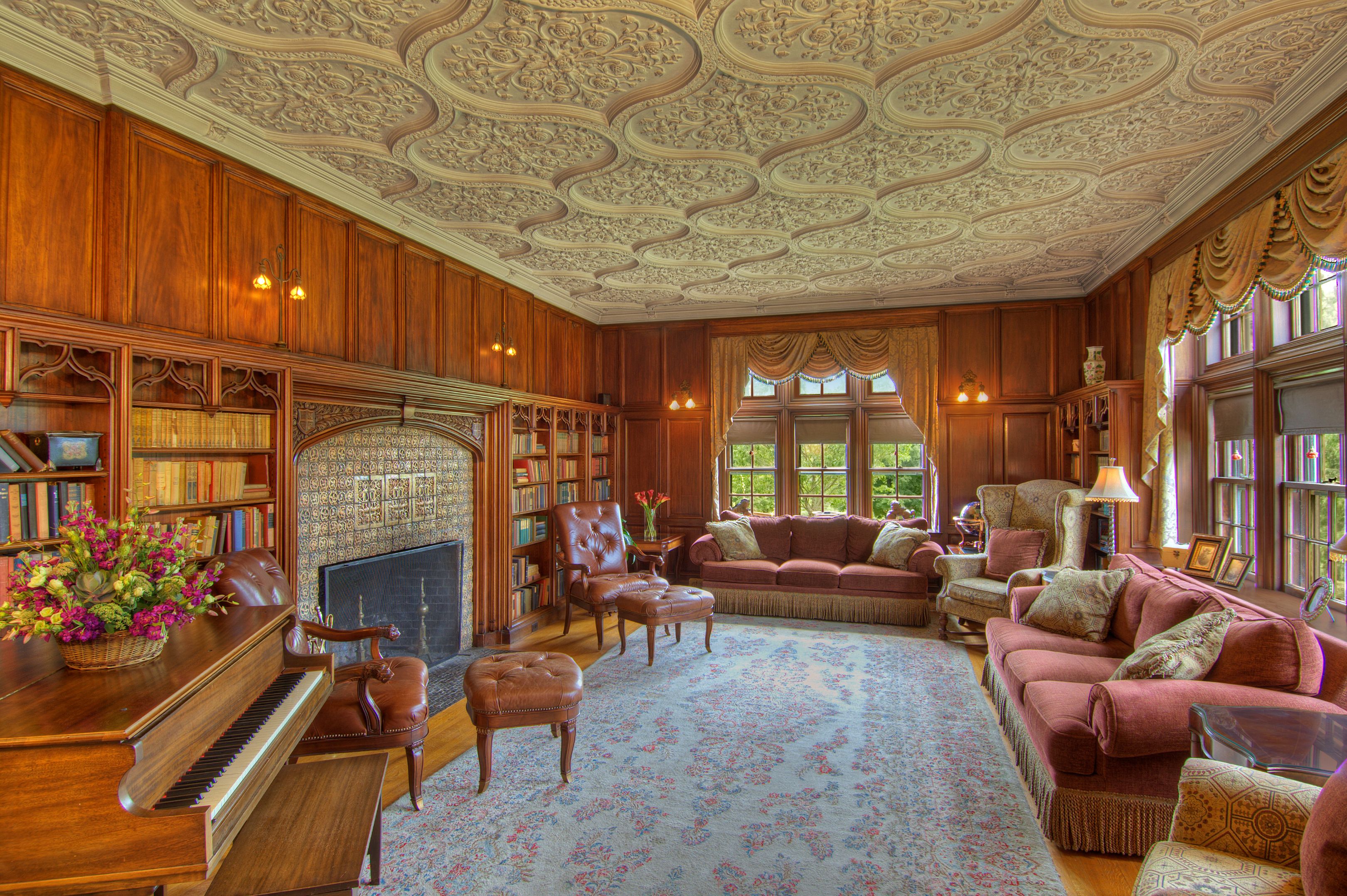 a room with a piano and bookshelves