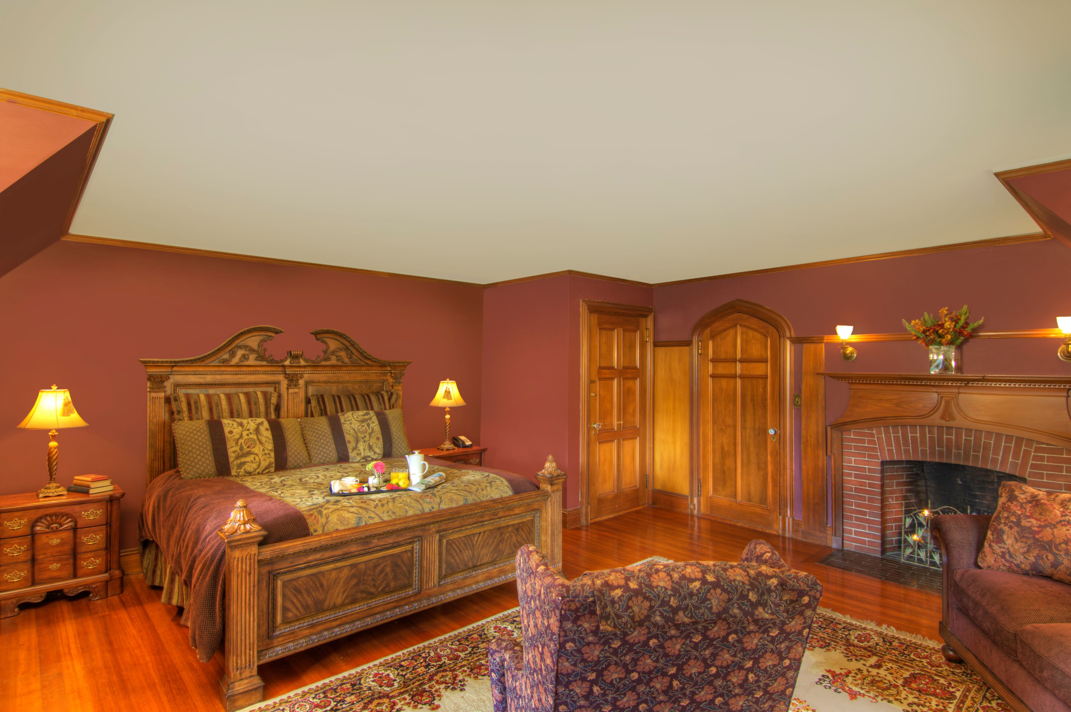 a bedroom with a fireplace and a bed