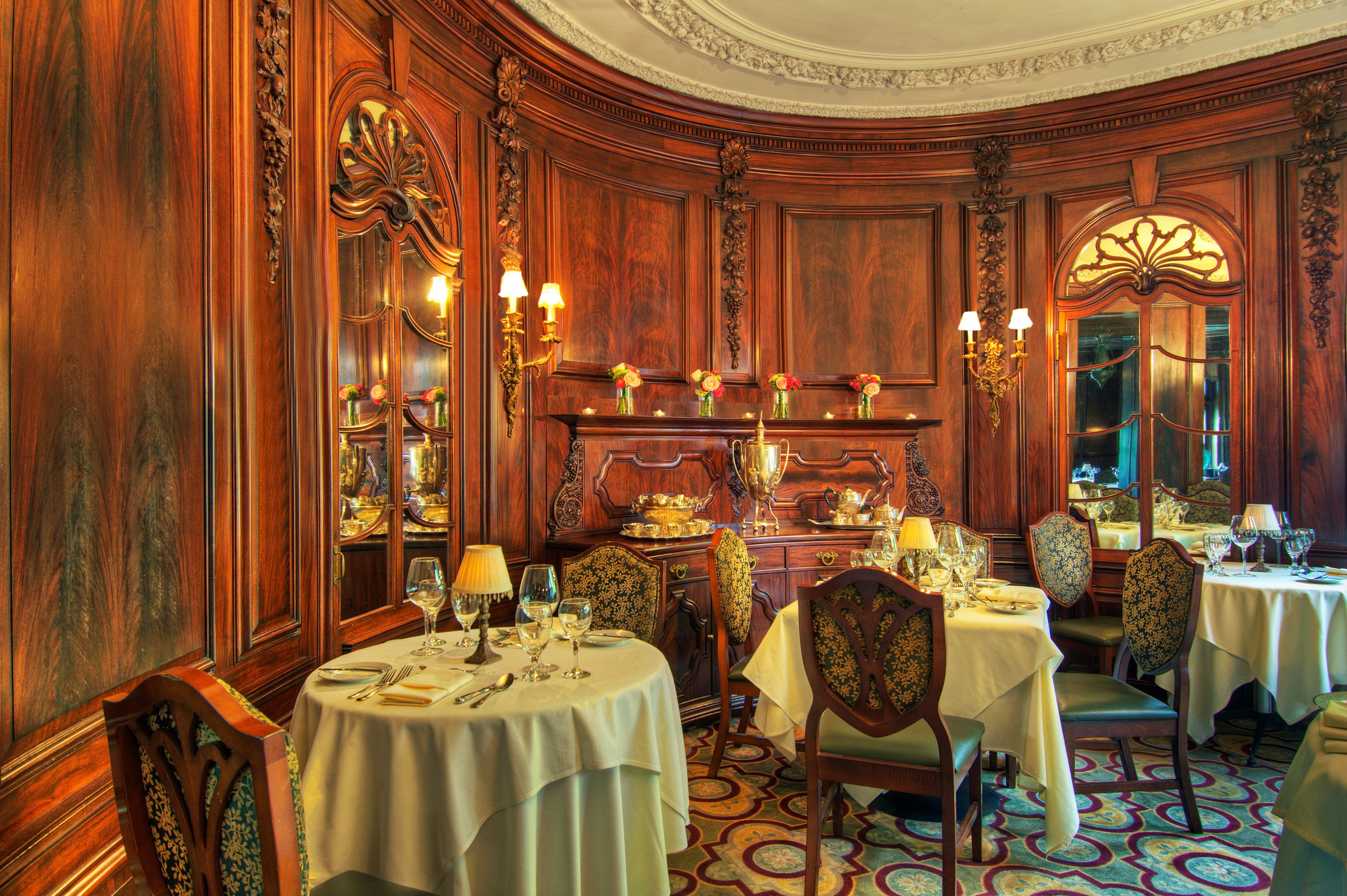 a room with a table set up and chairs