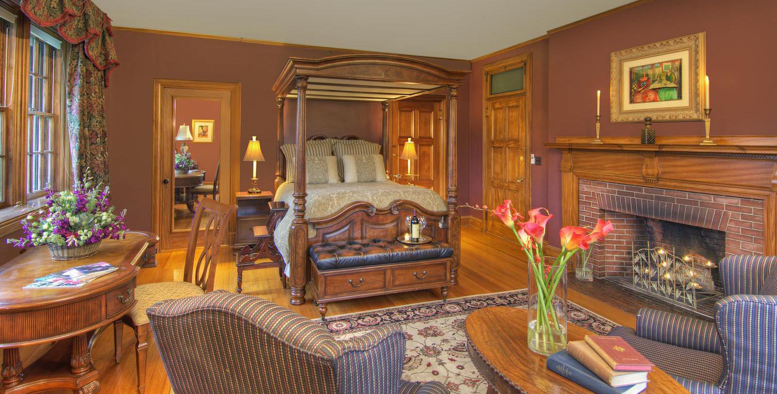 a bedroom with a four poster bed and a fireplace