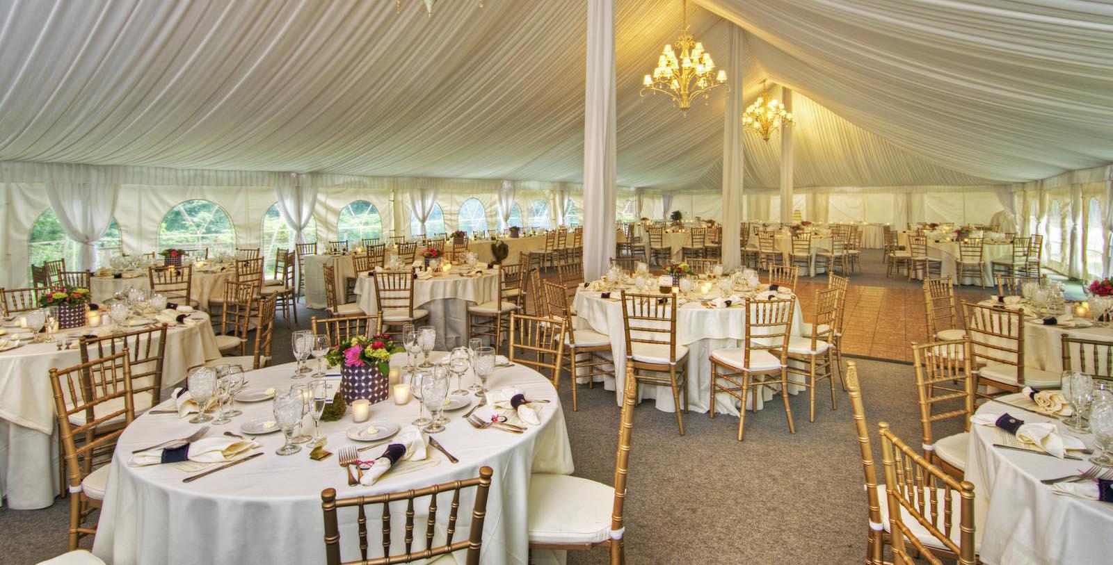 a large tent with tables and chairs