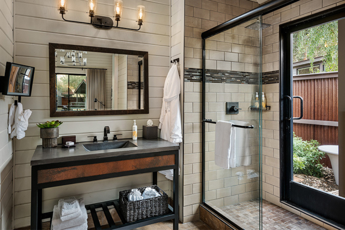 a bathroom with a glass shower and sink