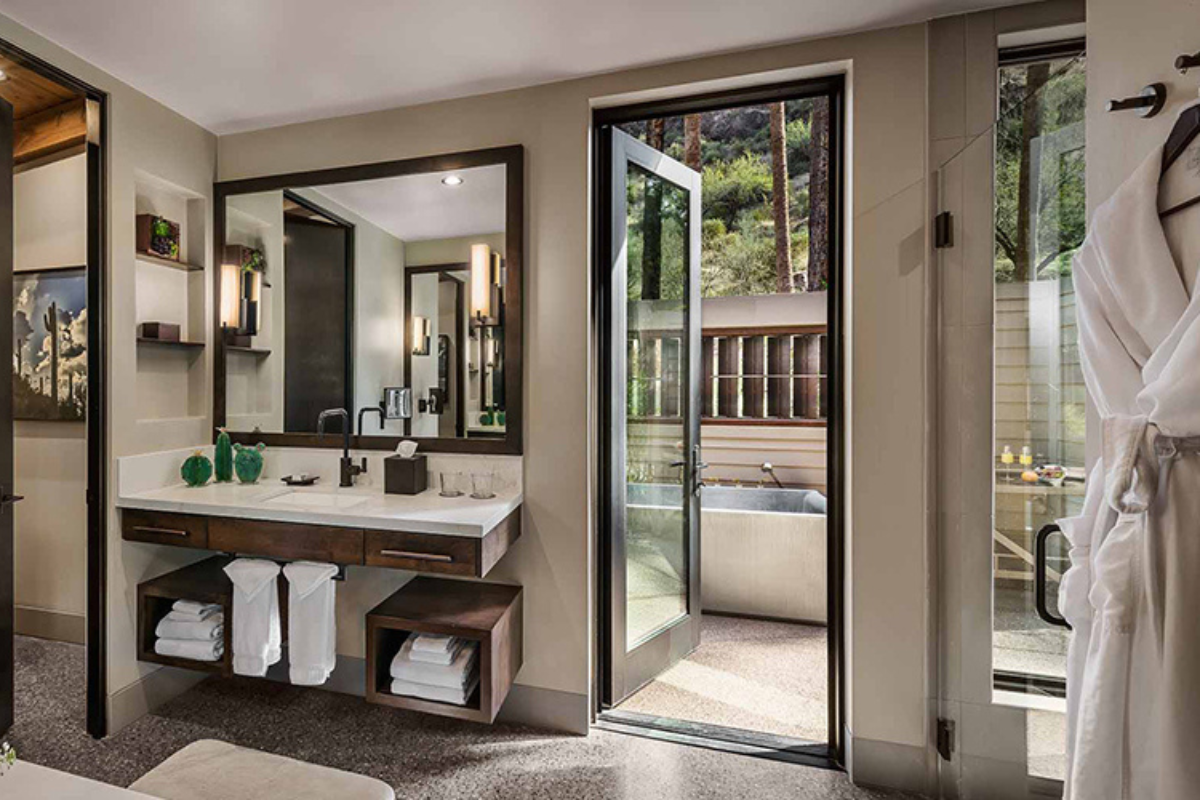 a bathroom with a glass door and a tub