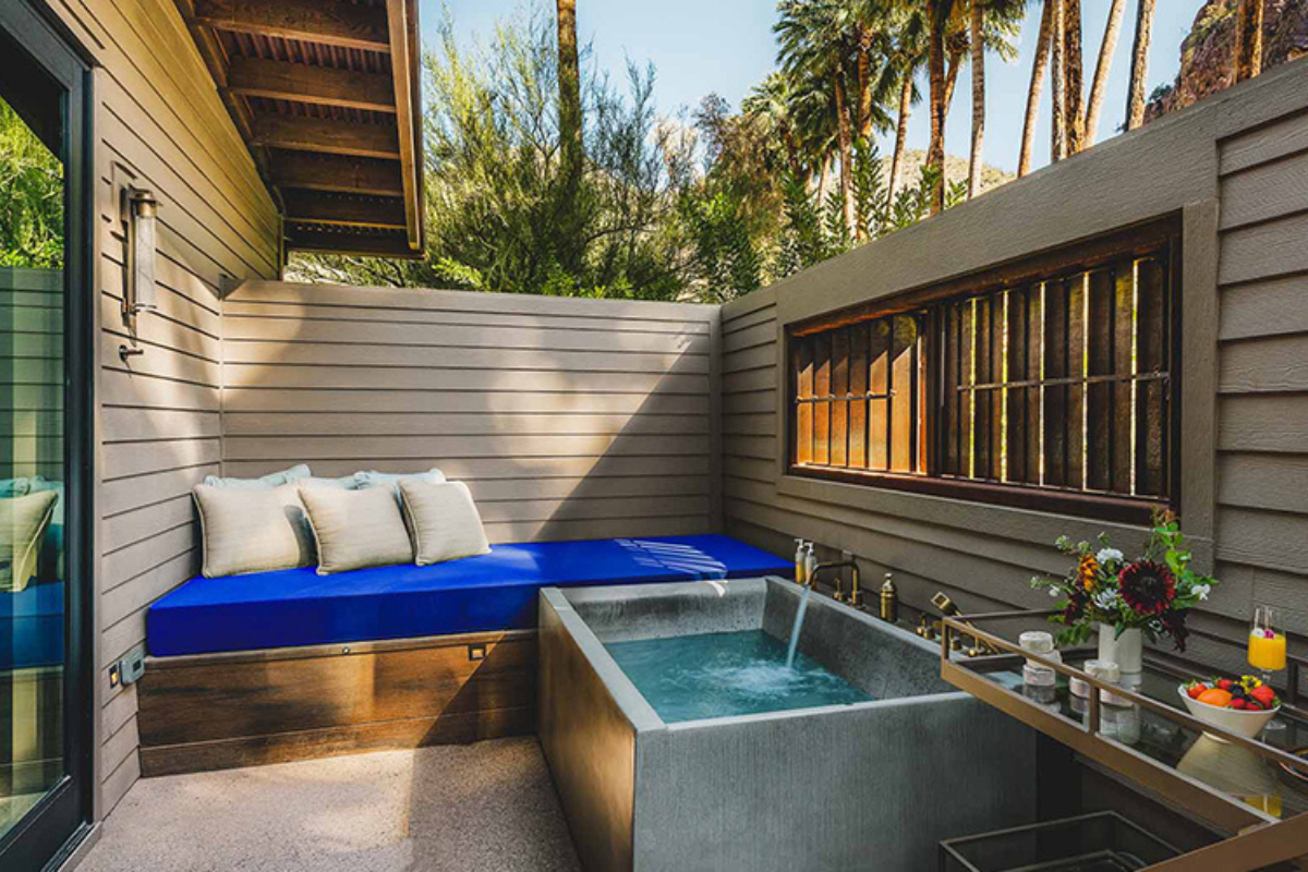 a patio with a blue cushion and a blue cushion