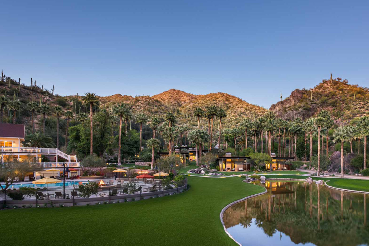 a pool and buildings in a resort