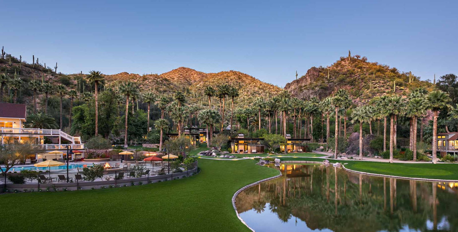 a house with a pool in front of a mountain