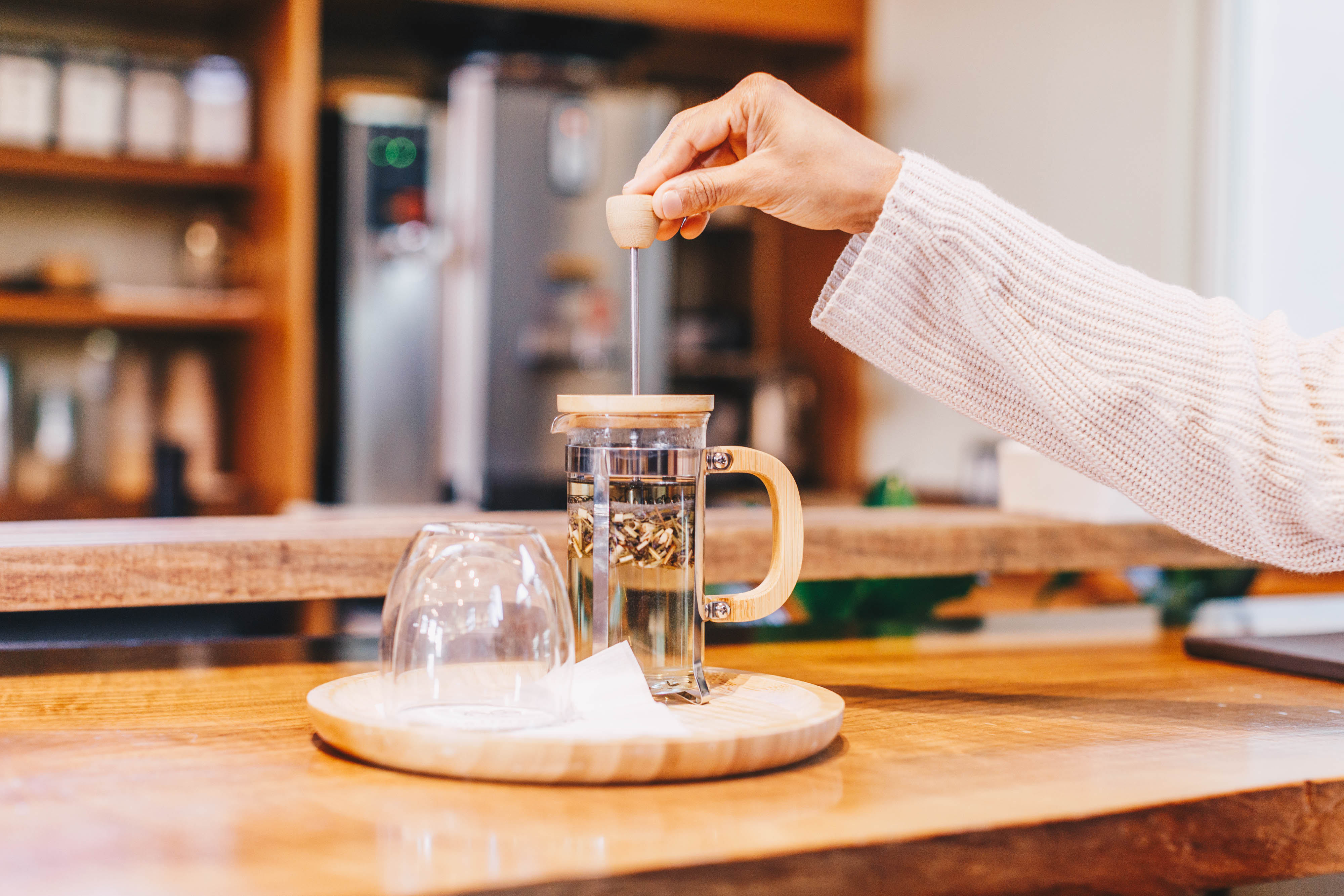 a person pouring liquid into a glass