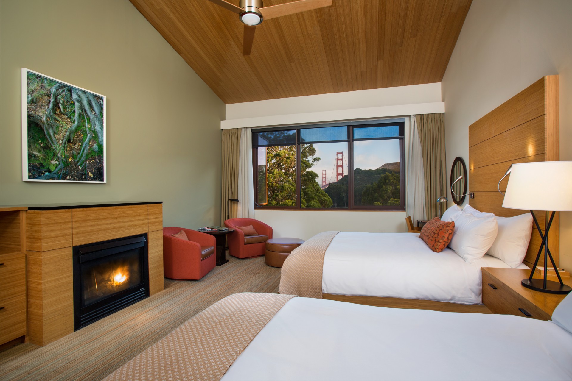 a room with two beds and a fireplace