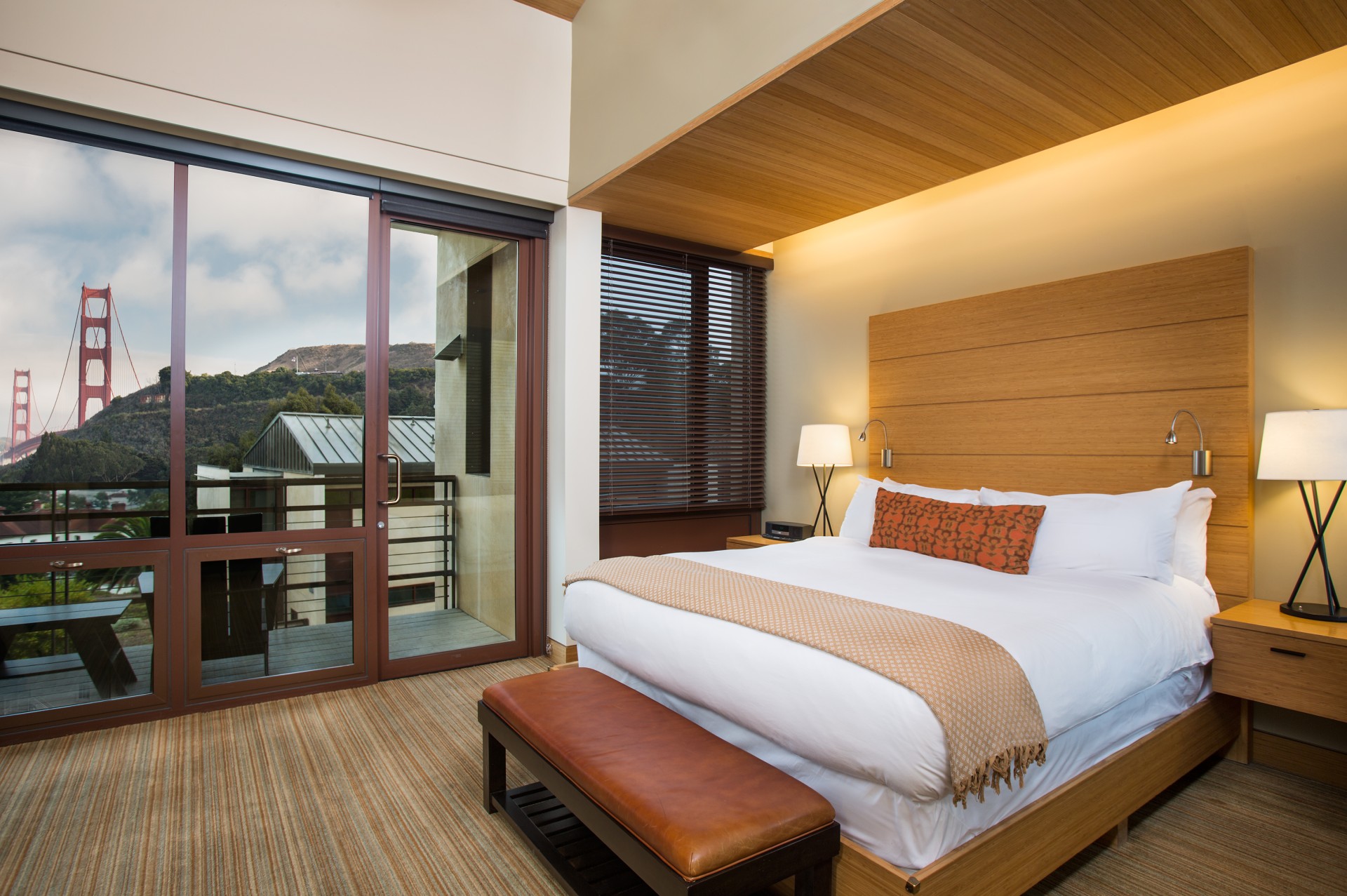 a bedroom with a bed and a glass door