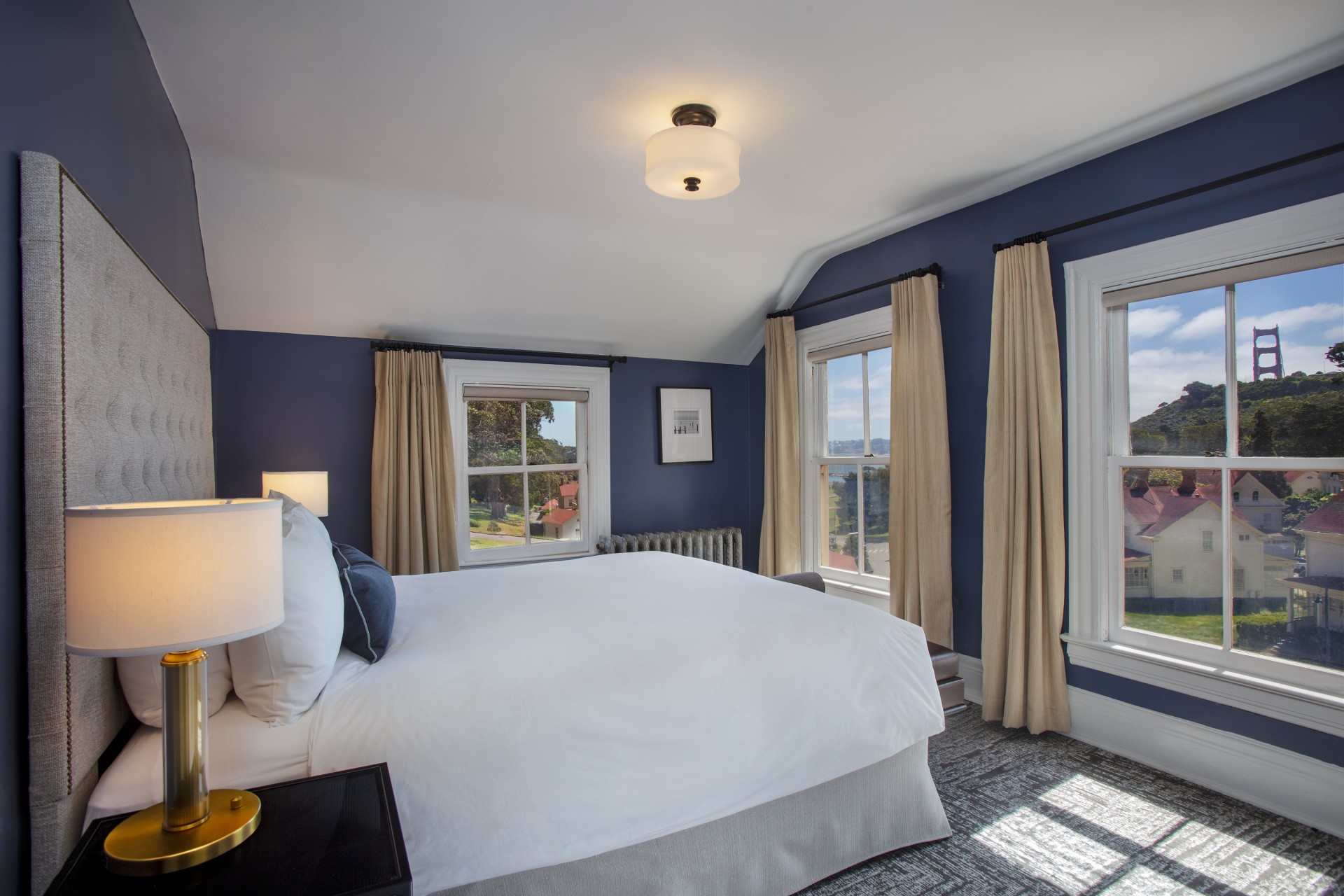 a bedroom with a bed and windows