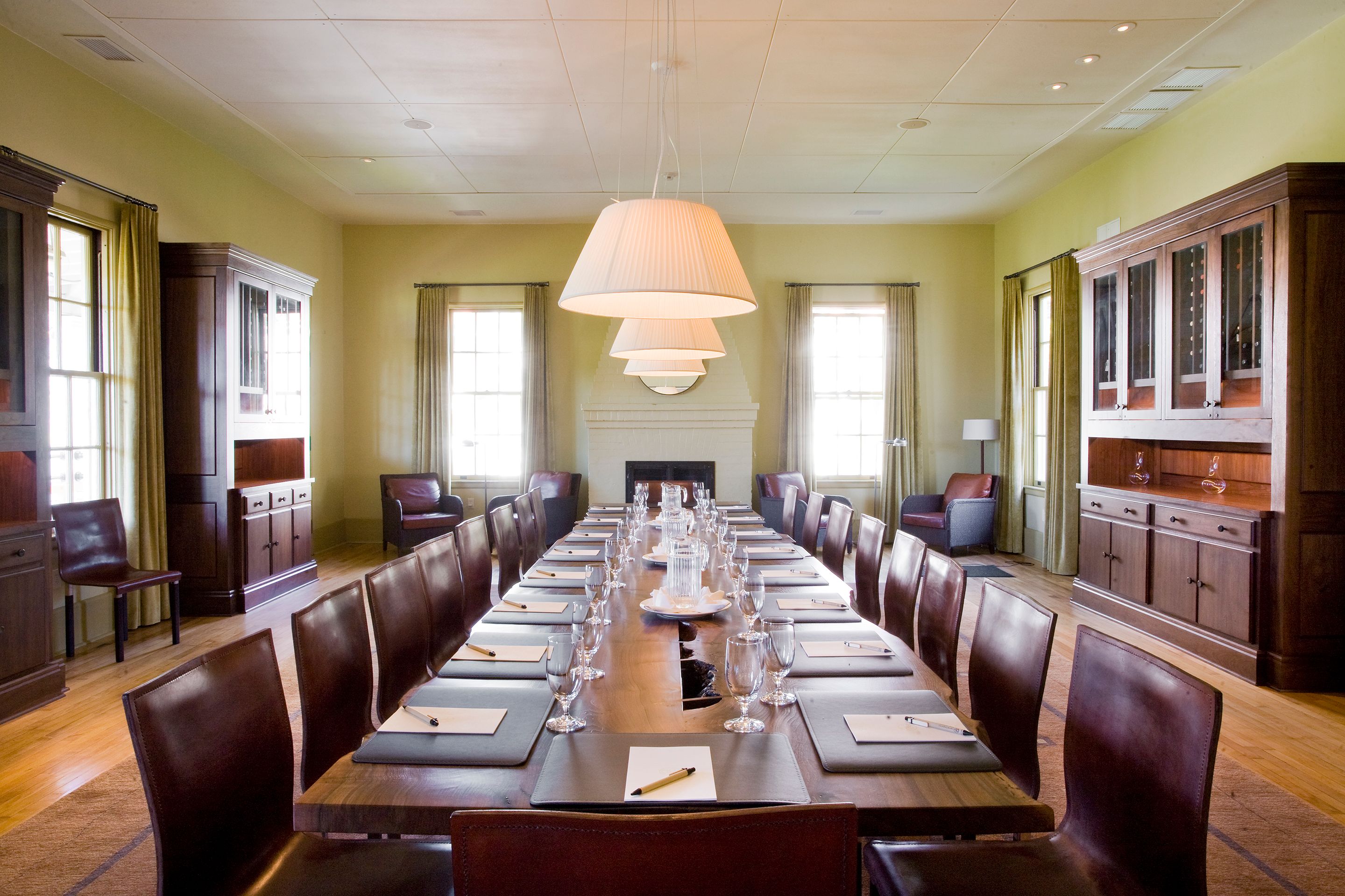 a long table with empty glasses and plates