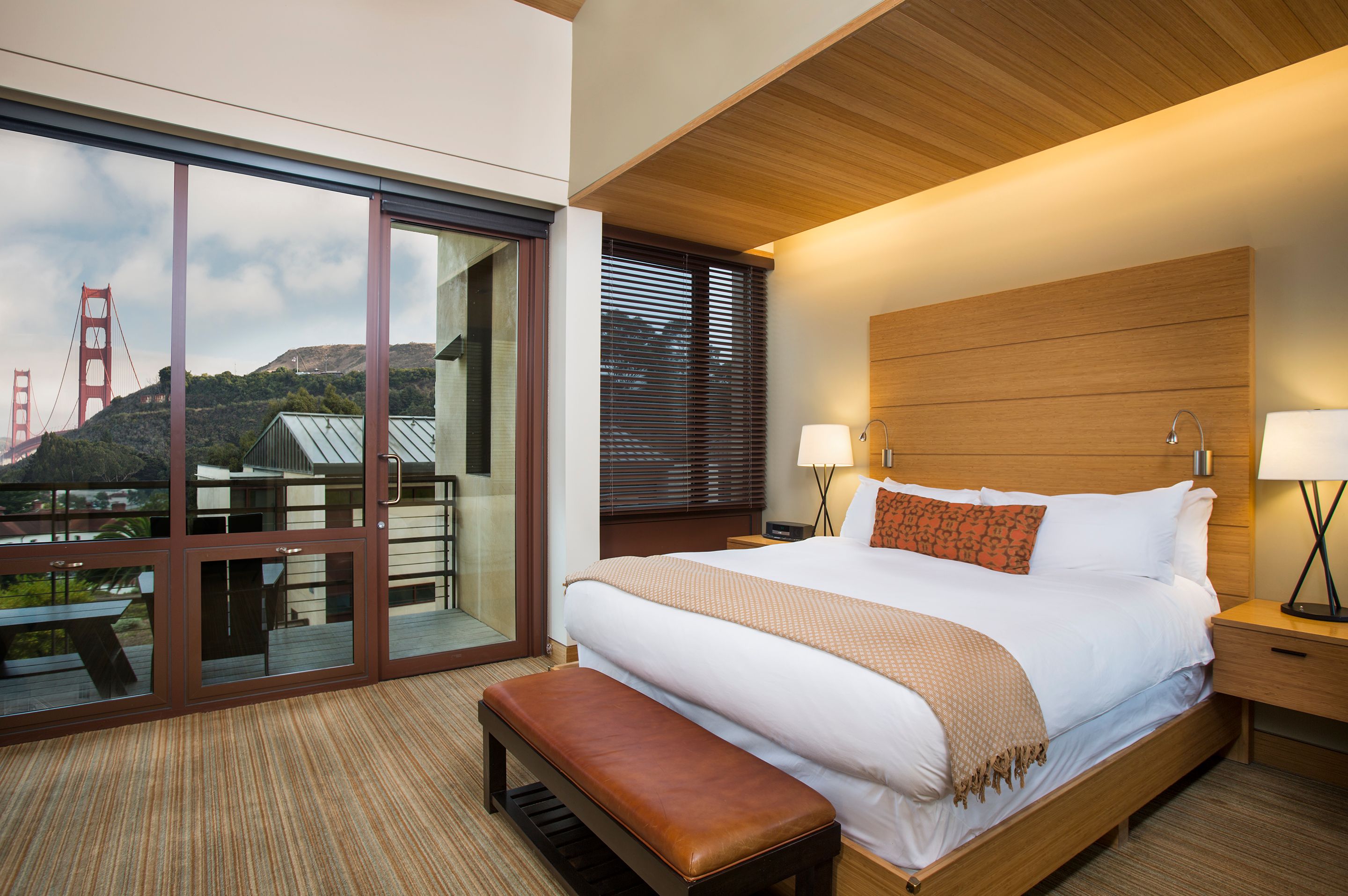 a bedroom with a bed and a bench