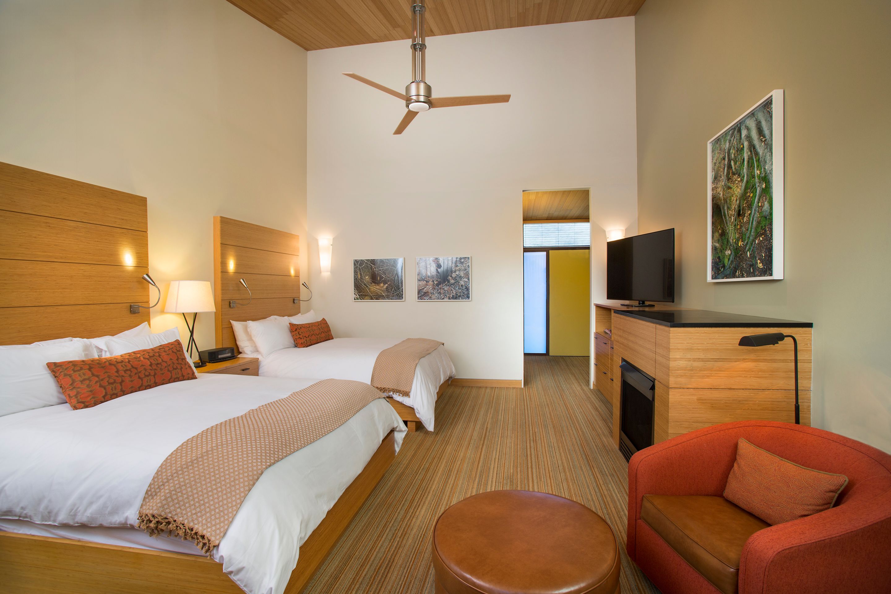a room with two beds and a television