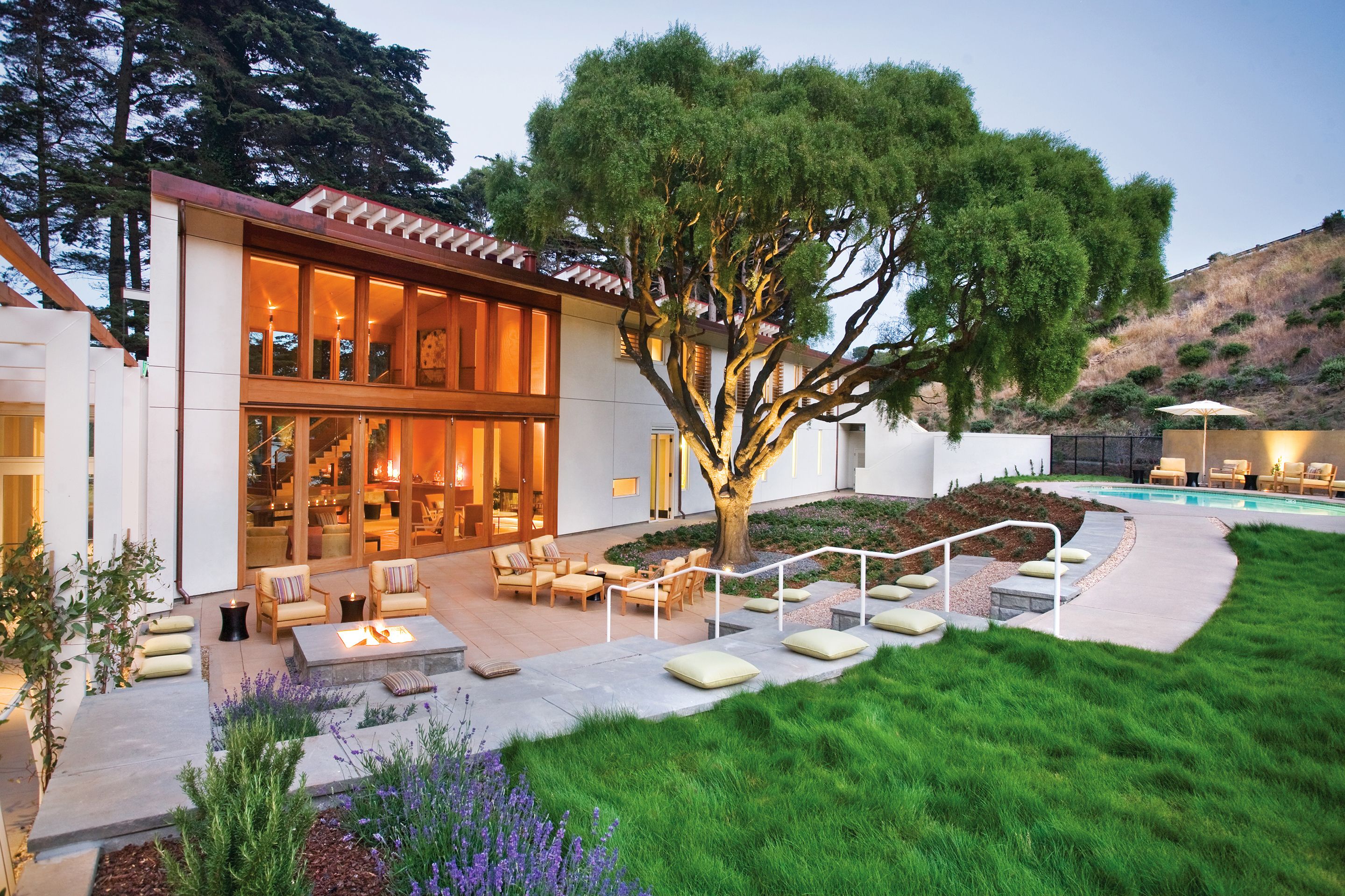 a house with a large tree and a fire pit