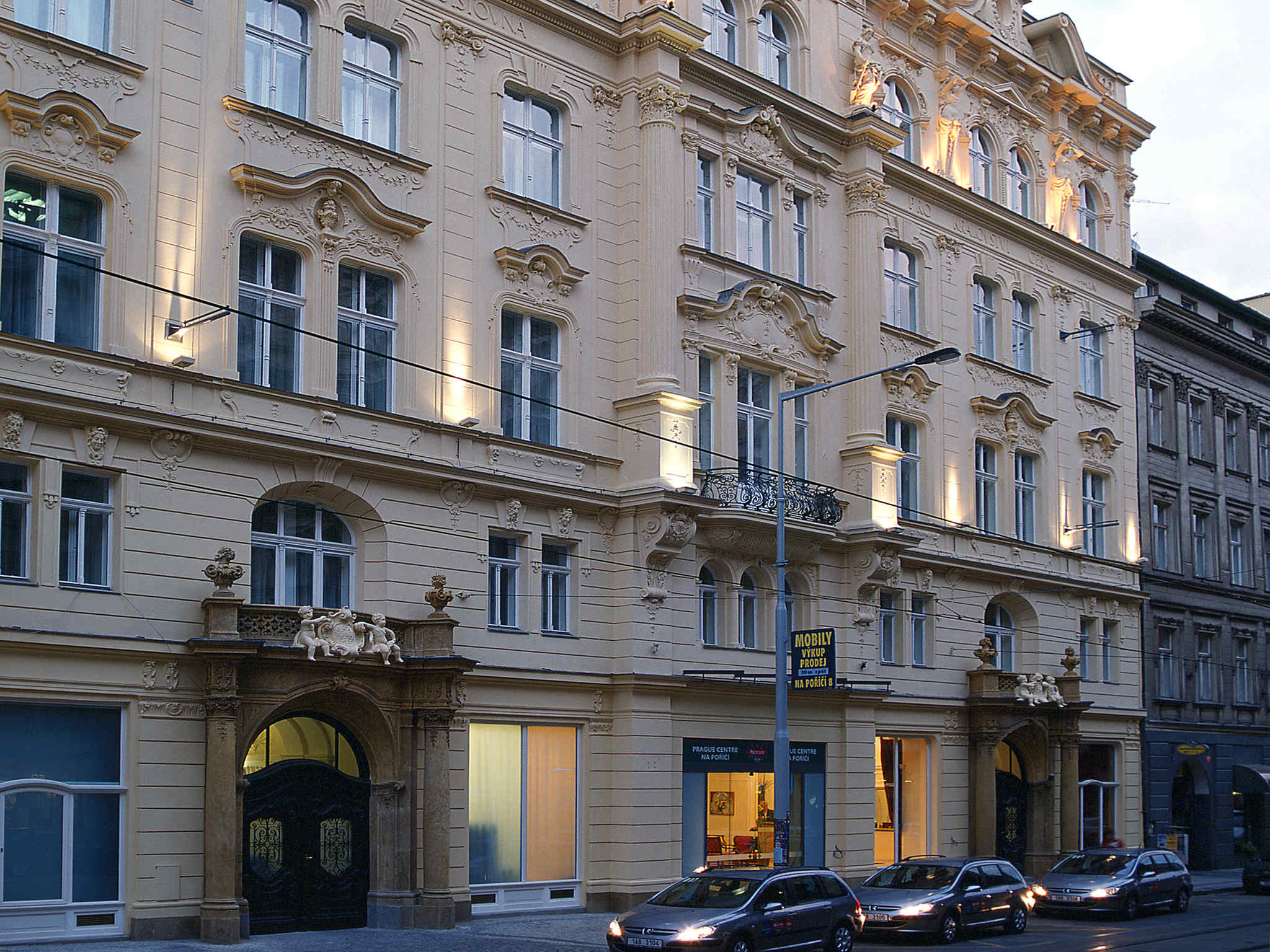 a building with many windows and cars parked on the street