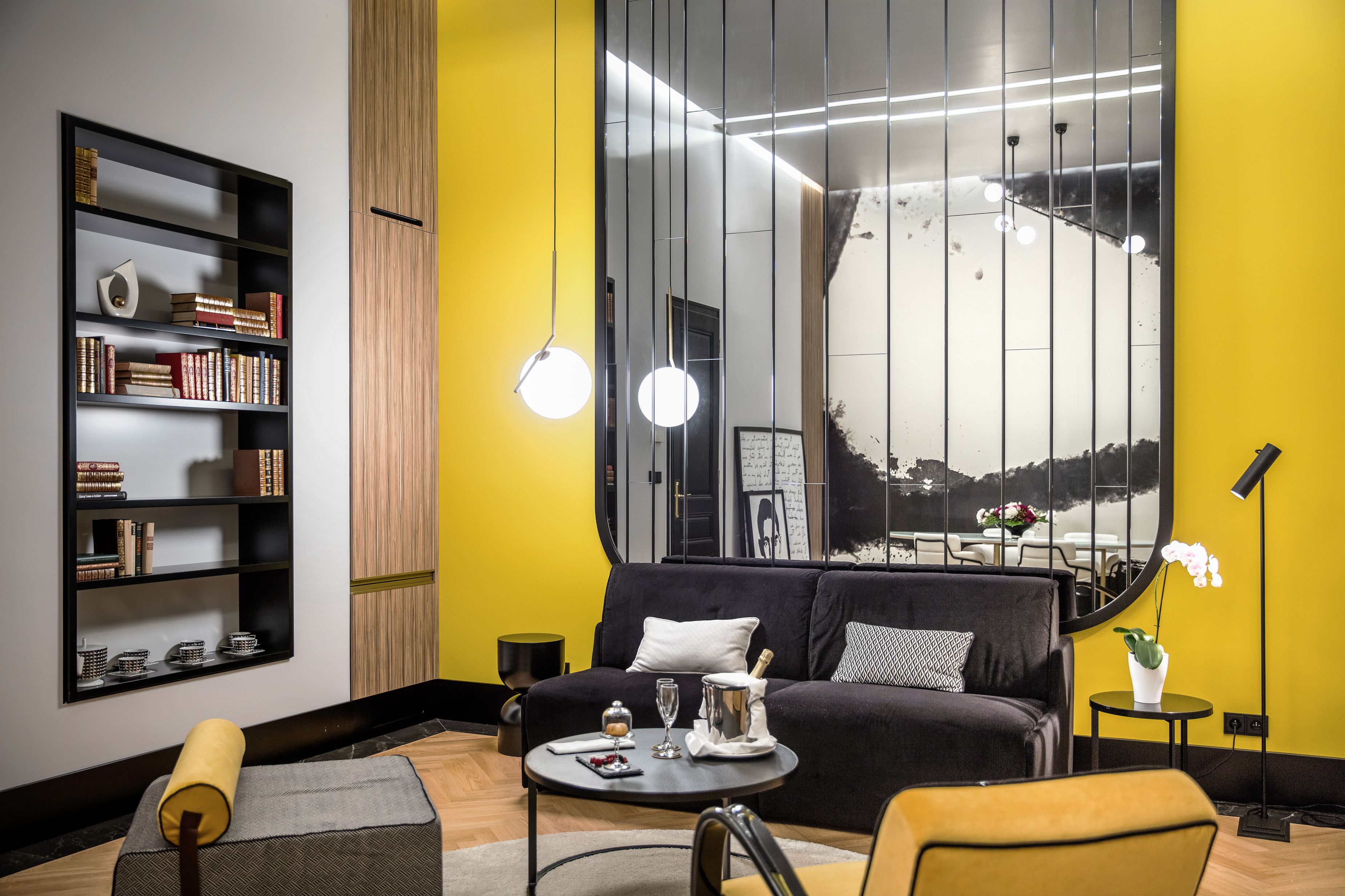 a room with yellow walls and a couch and a table