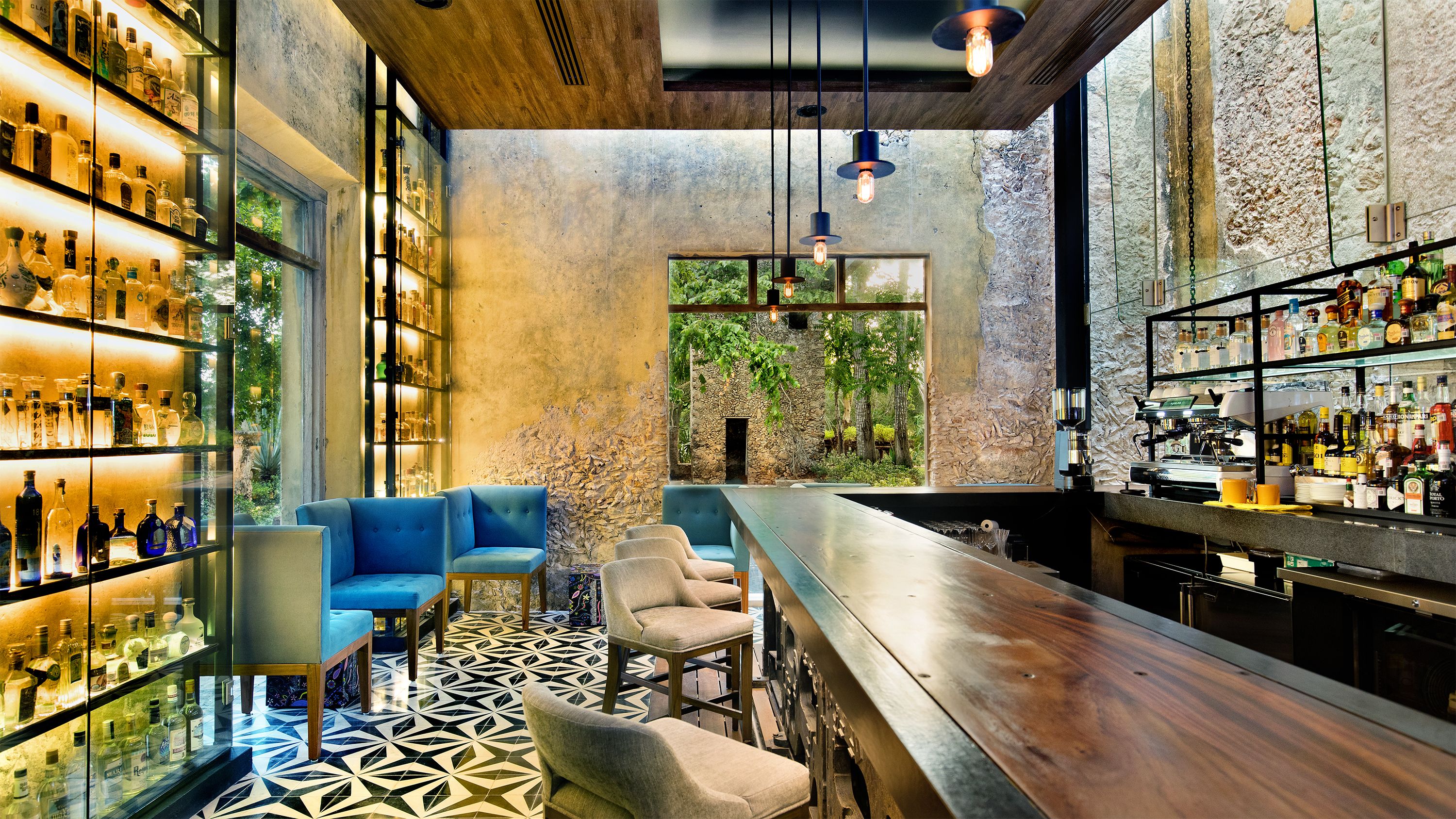 a room with a bar and chairs