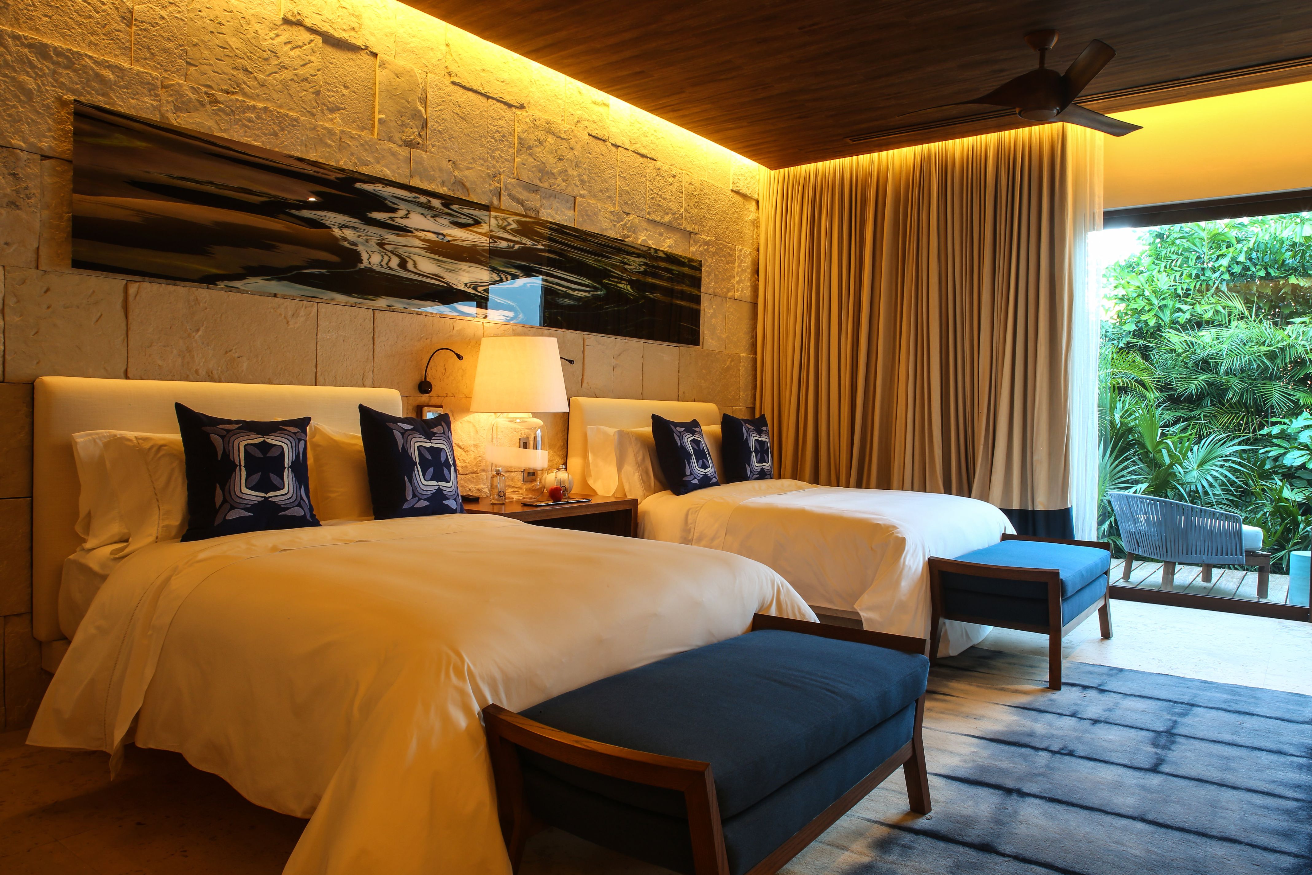 a room with two beds and a fan