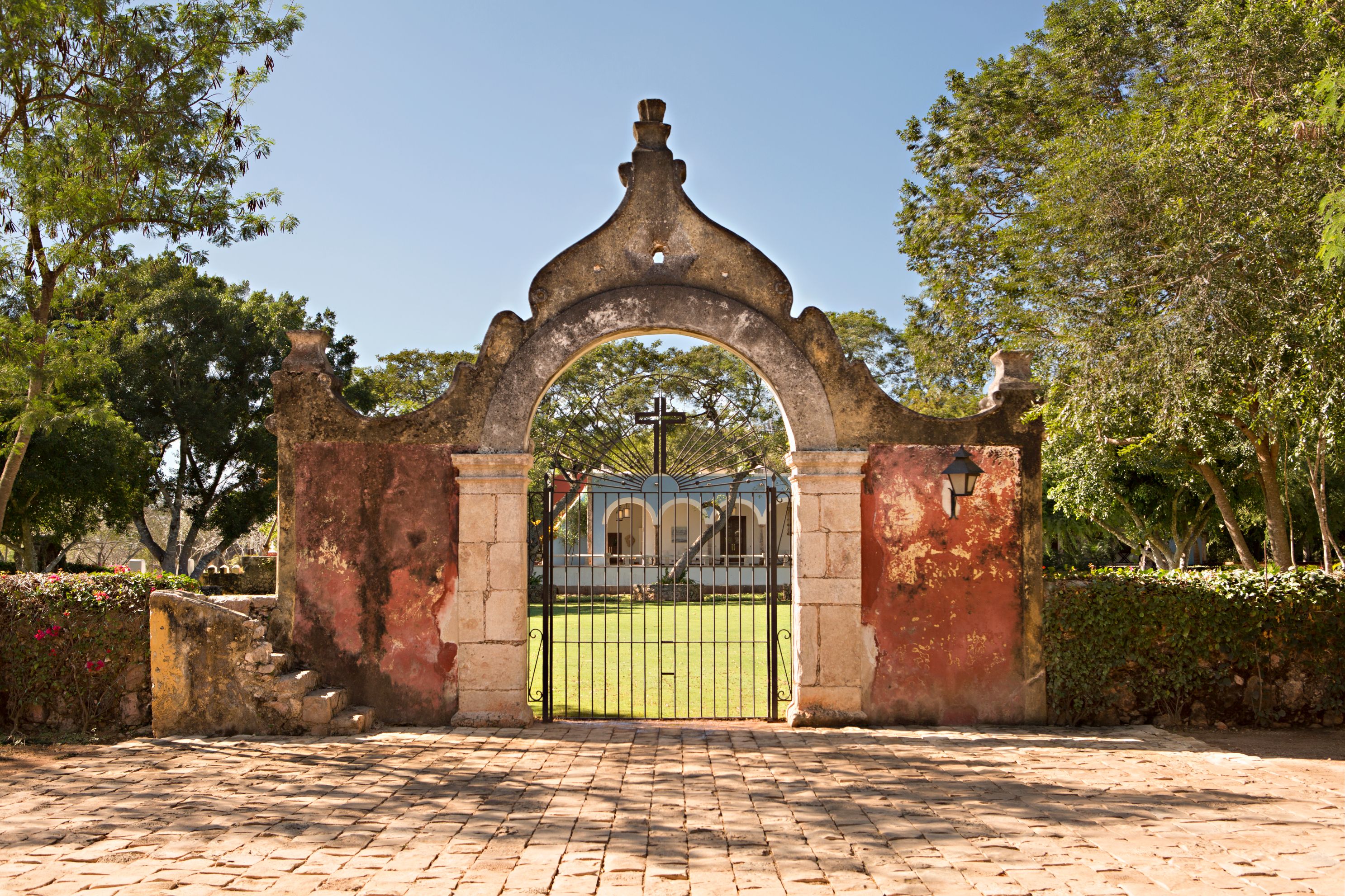 a gate with a fence and grass in the background