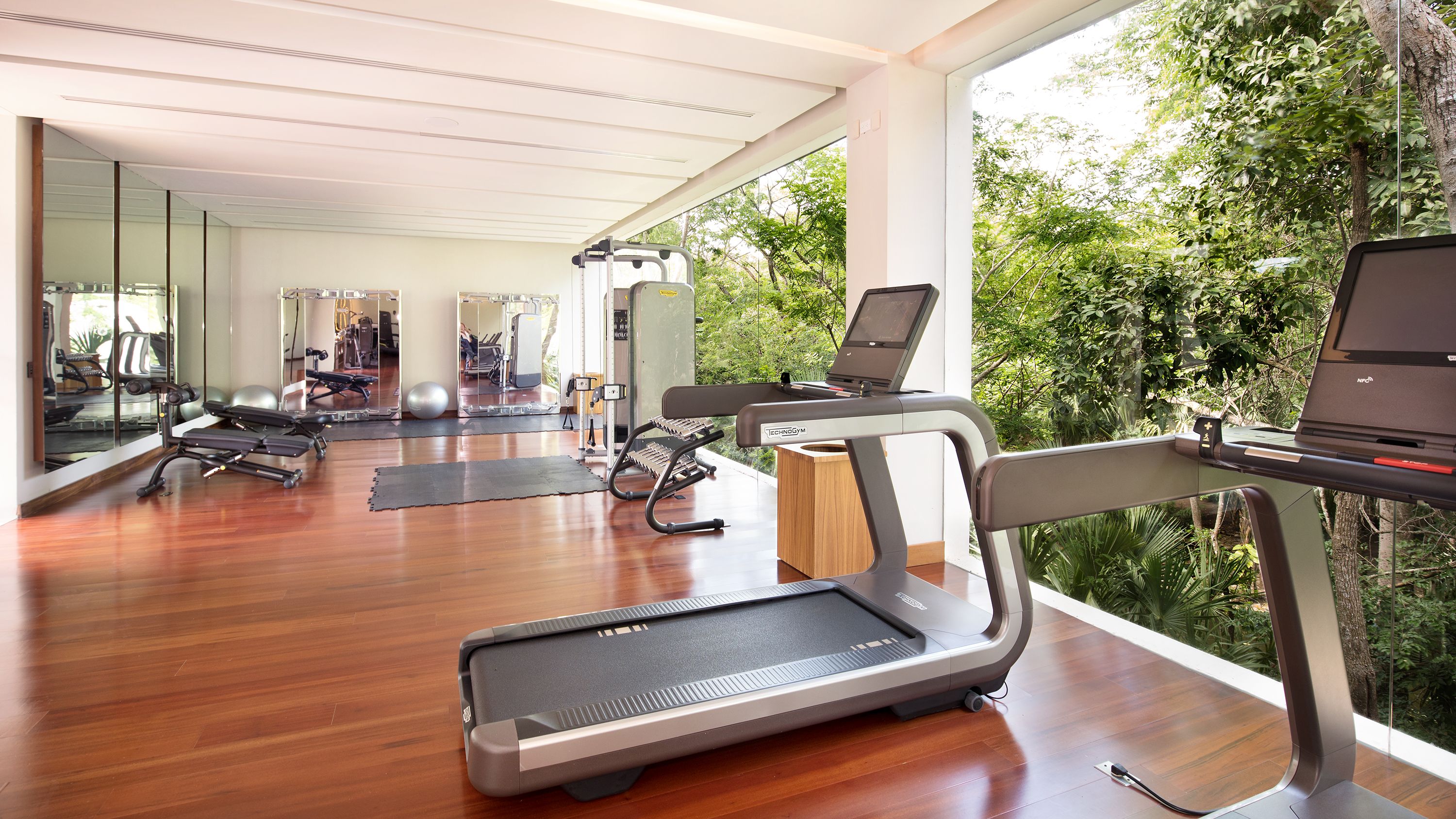 a gym with treadmills and exercise equipment