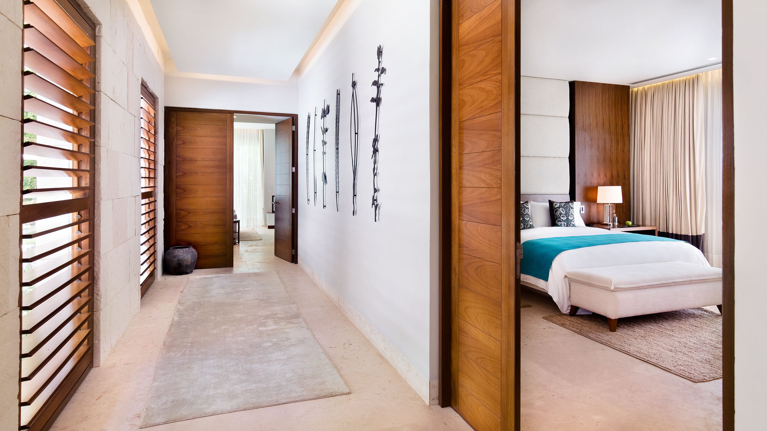 a hallway with a bed and a rug
