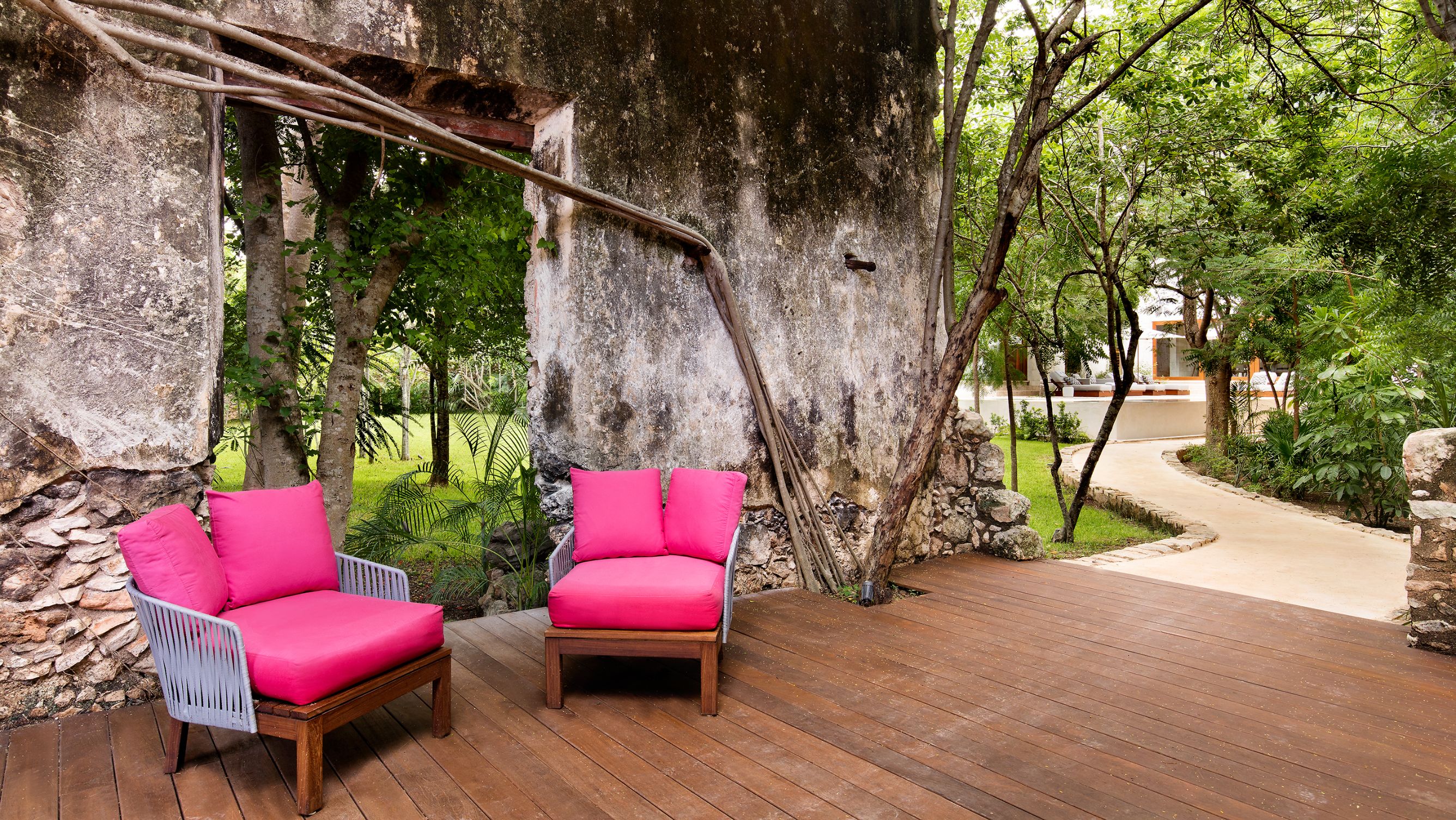 a two pink chairs on a deck