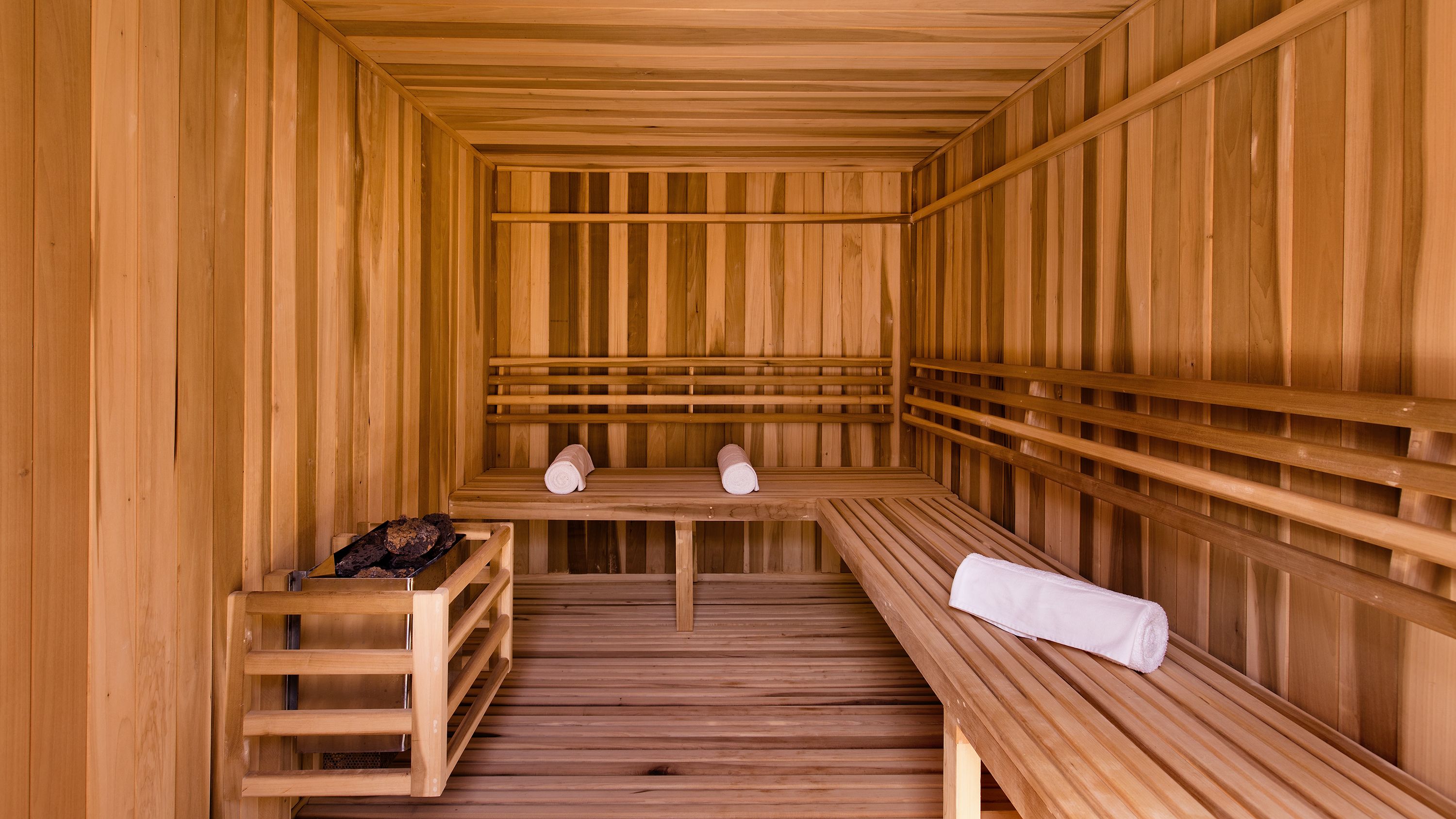 a wooden sauna with benches and towels