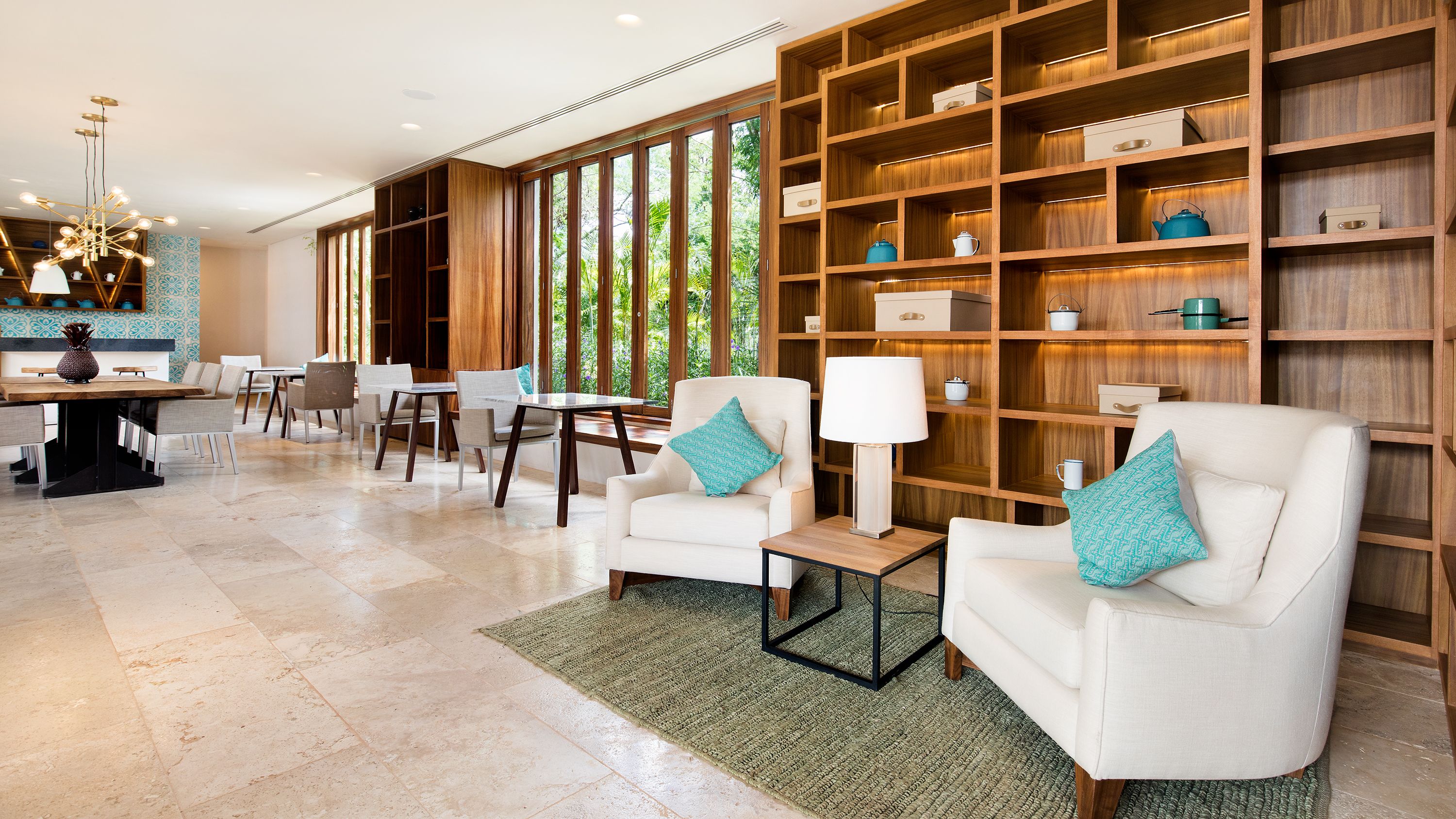 a room with a bookcase and chairs