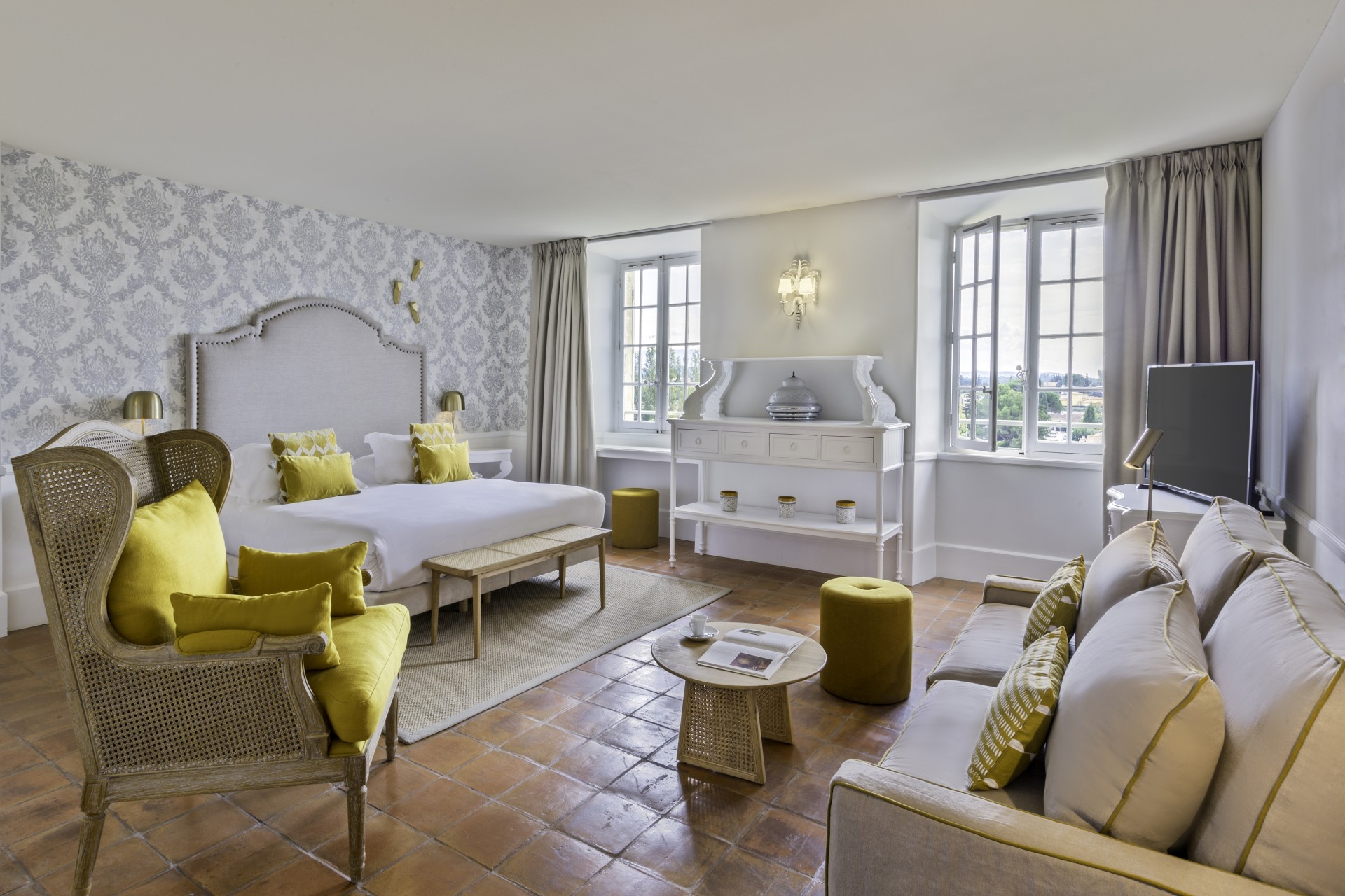 a room with a bed and couches
