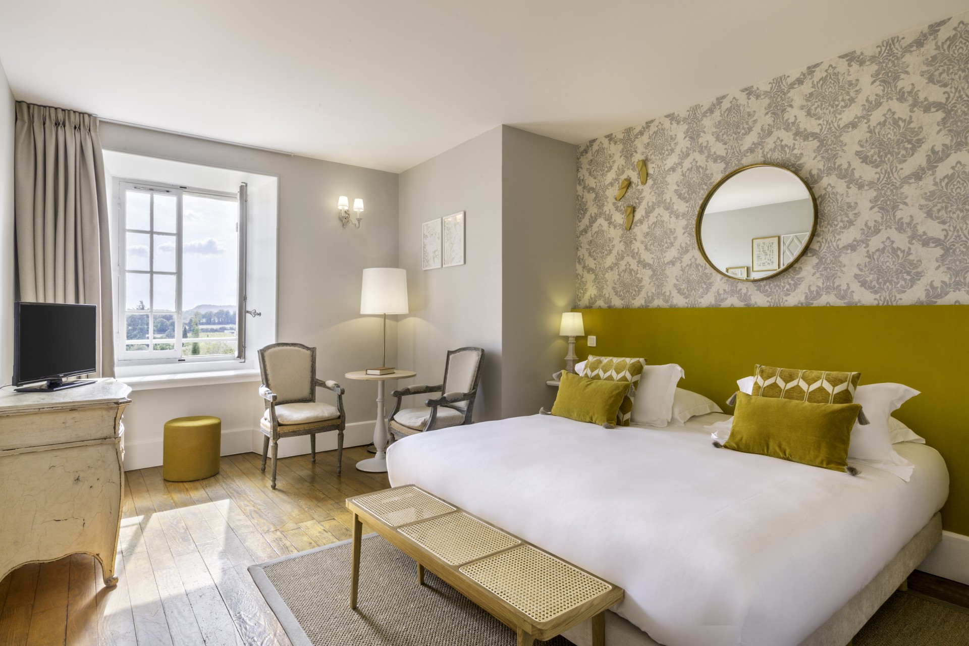 a bedroom with a bed and chairs